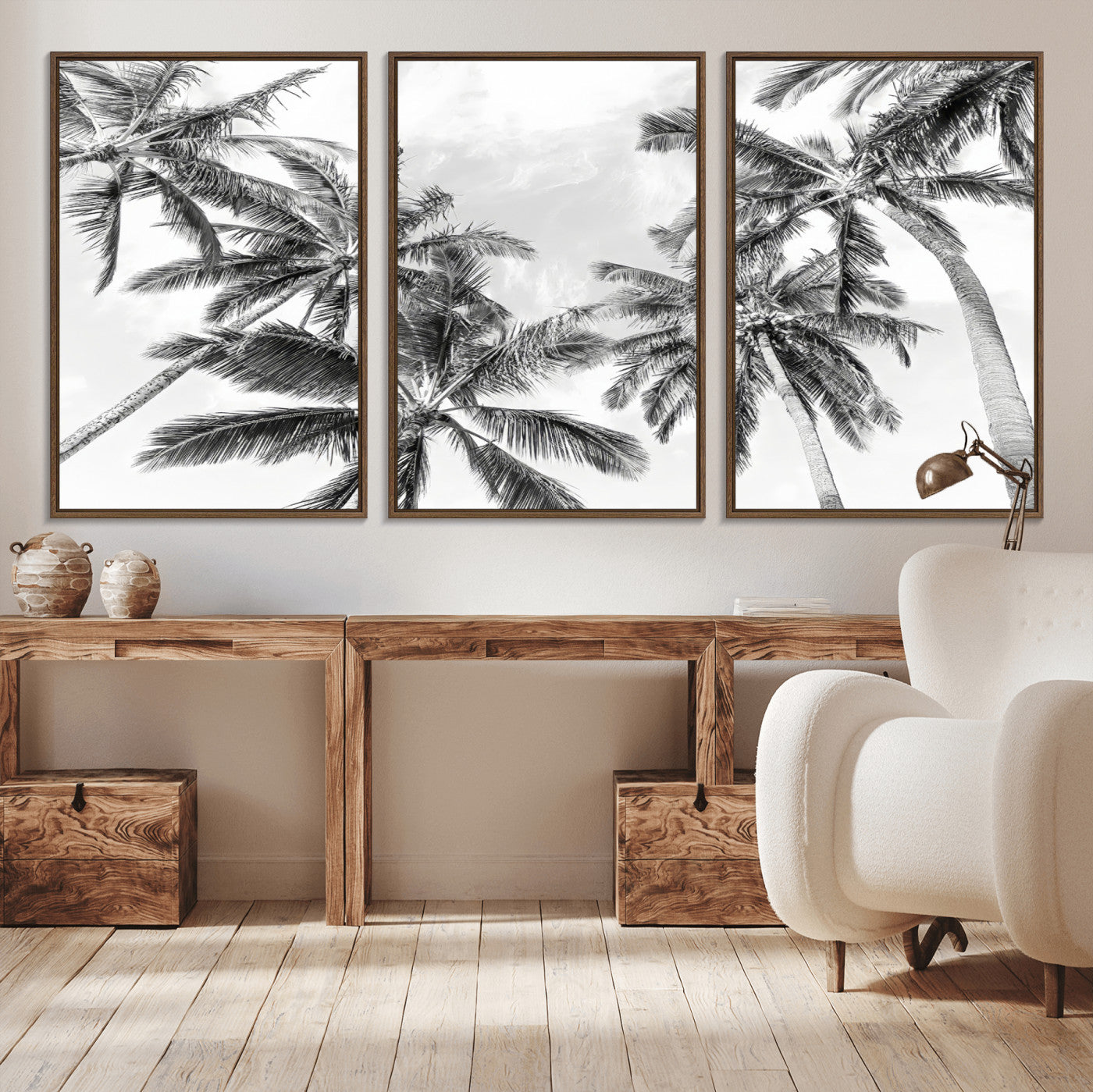 Black and white tropical palm trees viewed from below, swaying gently against a bright sky, creating a serene and elegant coastal atmosphere.