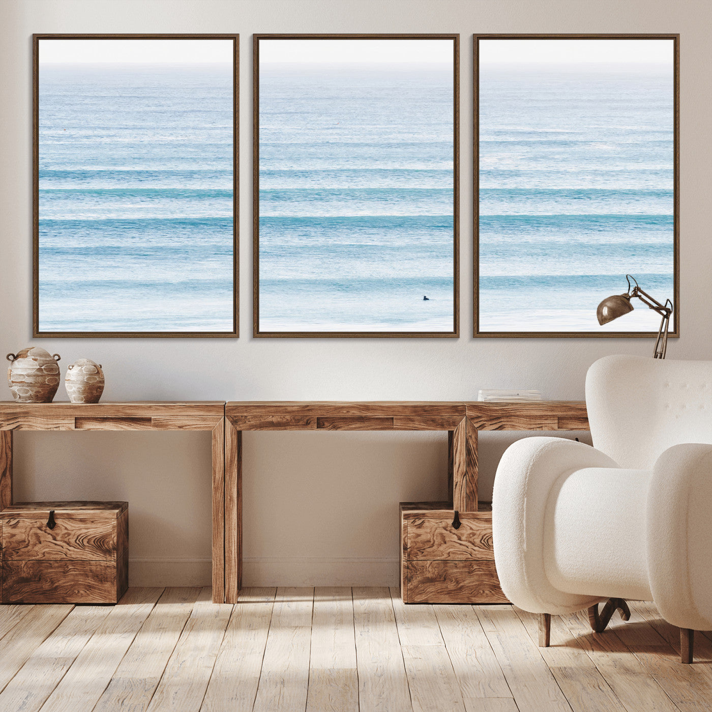 Minimalist ocean view with soft blue waves and a lone surfer, creating a serene and airy coastal aesthetic, perfect for tranquil home decor.