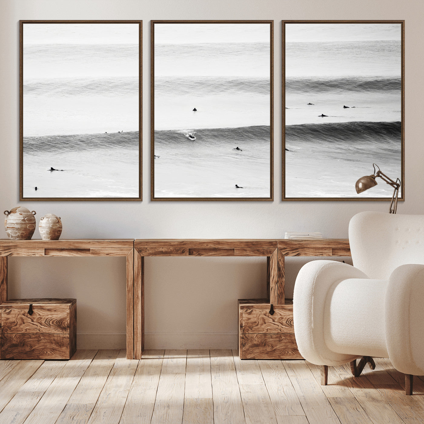 A monochrome photograph of swimmers gliding through gentle ocean waves, evoking a sense of calm and movement.