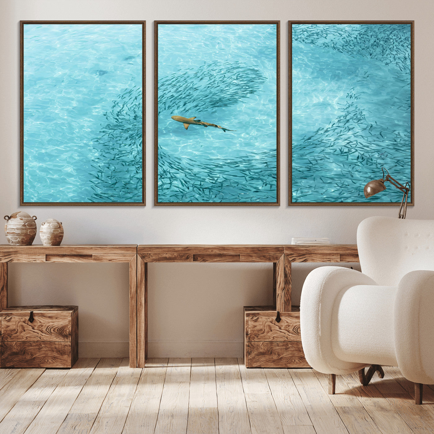 Aerial view of a shark swimming through a swirl of fish in clear turquoise waters, perfect for calm coastal or beach house decor.