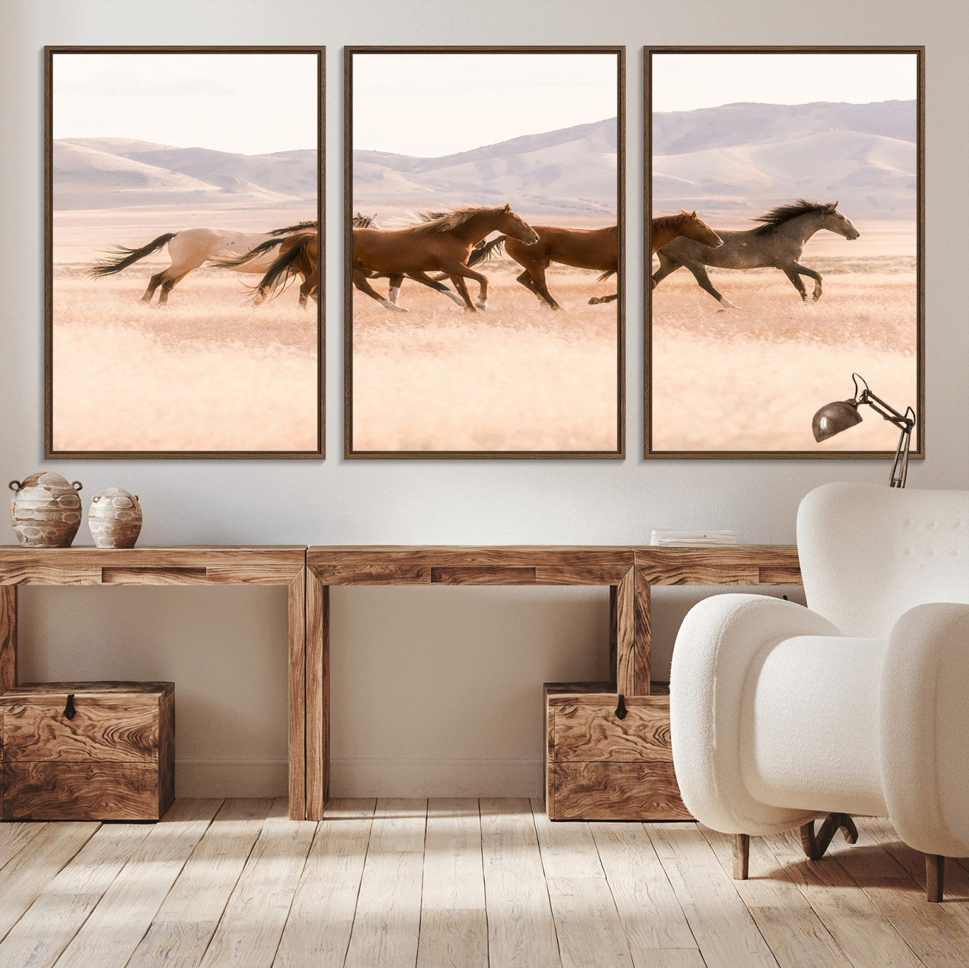 A herd of wild horses galloping through a sunlit desert plain with mountains in the background, perfect for rustic or western-themed wall decor.