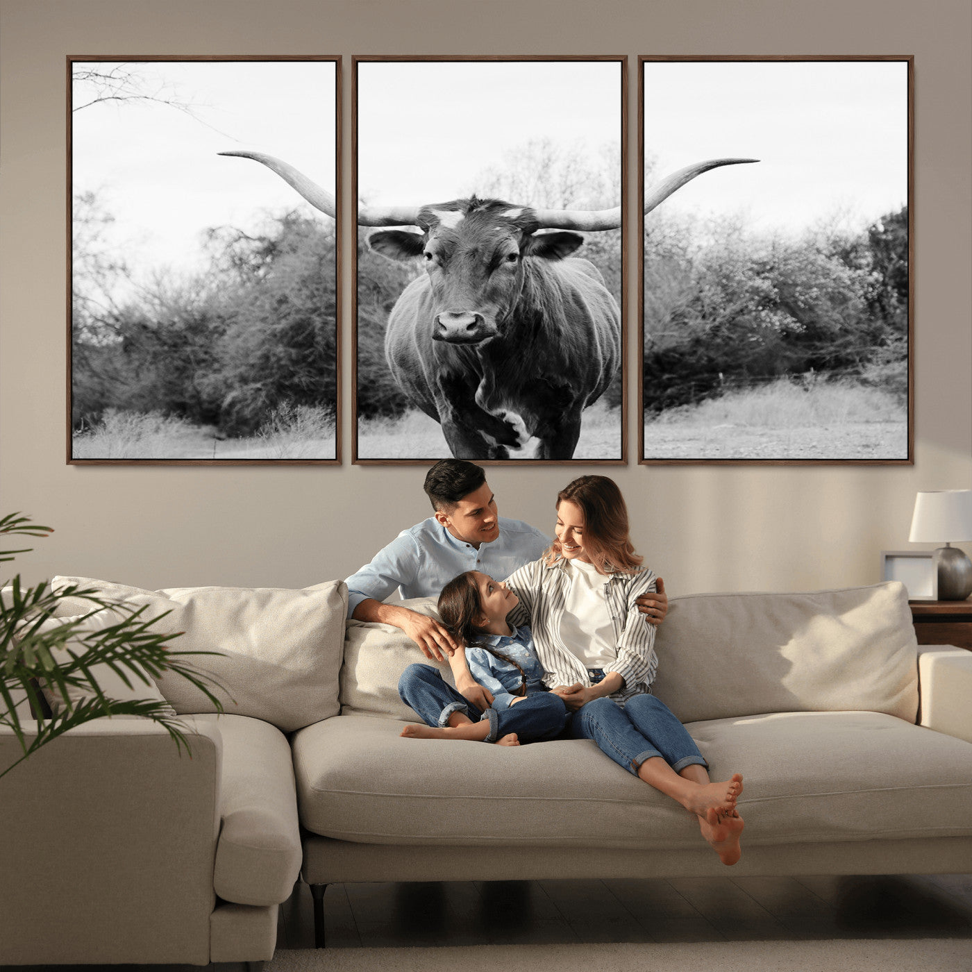 Black and white photo of a longhorn cow in a field, perfect for rustic farmhouse or western-themed interior wall decoration.