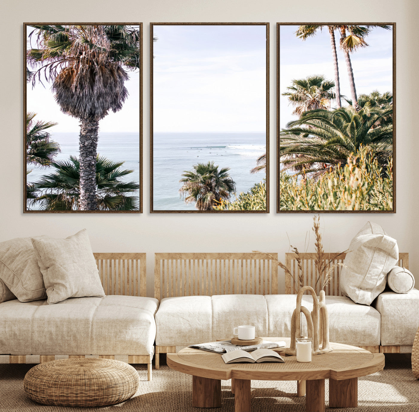 Scenic coastal view with tall palm trees overlooking a calm ocean, soft blue waves, and surfers in the distance, creating a peaceful tropical vibe.