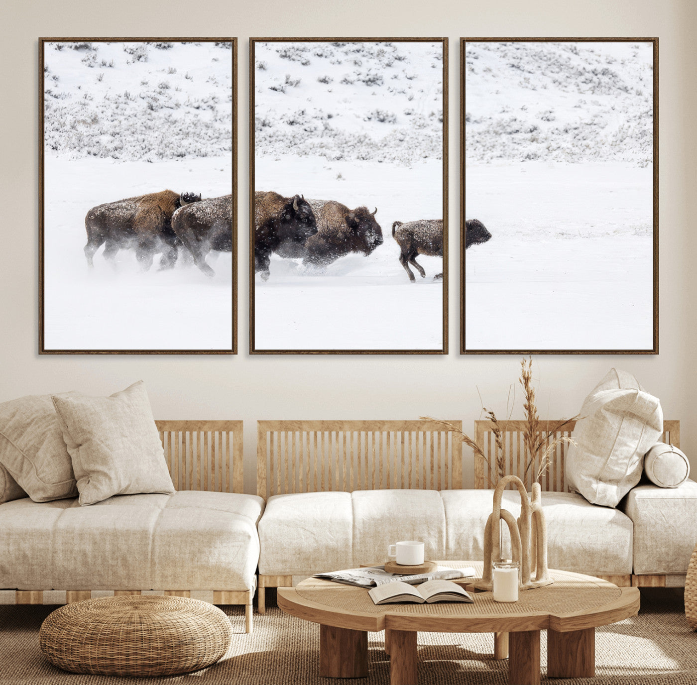 Bison herd running through a snowy open field with mountain backdrop, perfect for rustic or western-themed wall decoration.