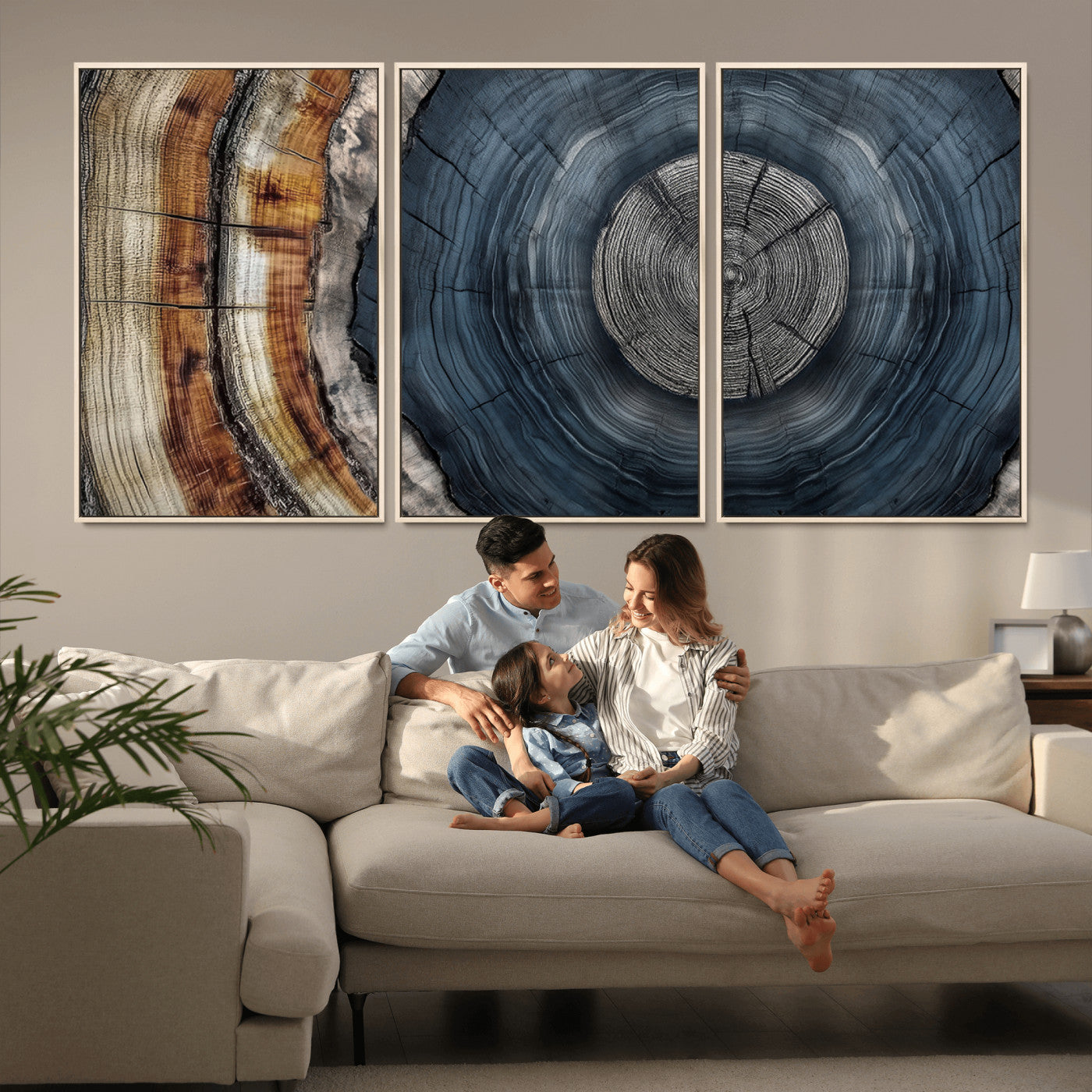 A stunning close-up of a tree trunk showing the intricate, circular growth rings, showcasing the natural textures and rich contrasts in deep blues, browns, and silvers.