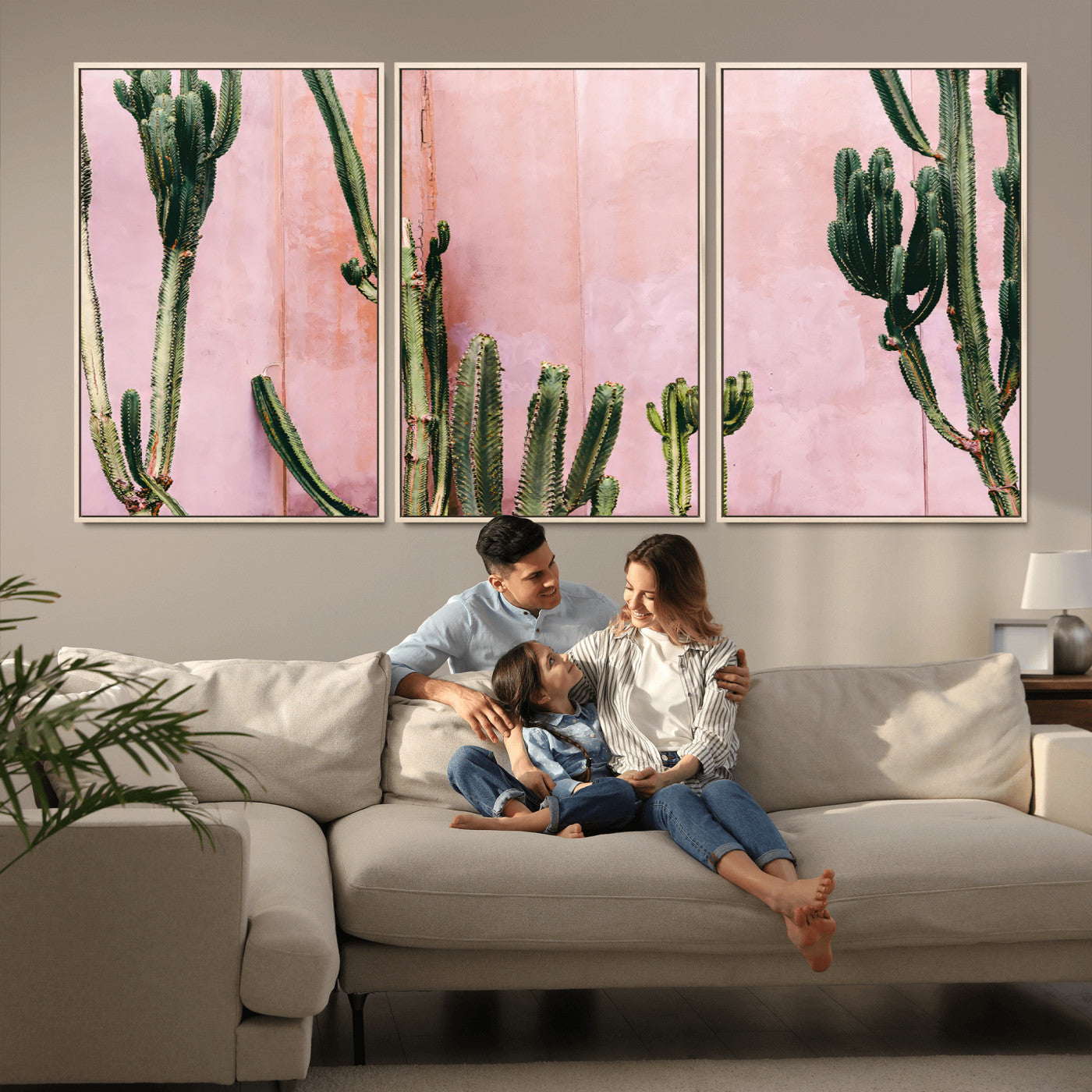 Framed canvas of tall green cacti against a soft pink wall, ideal for modern desert or colorful southwest-inspired home decor.