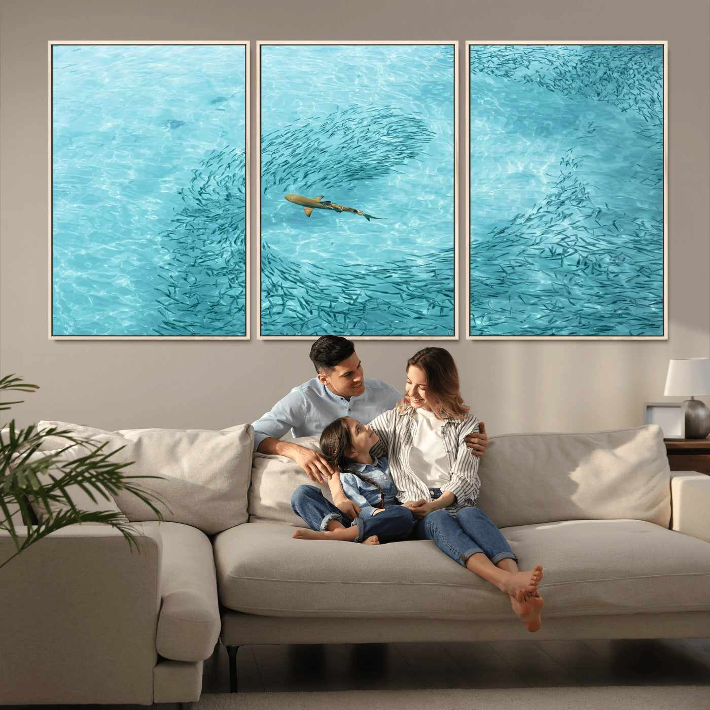Aerial view of a shark swimming through a swirl of fish in clear turquoise waters, perfect for calm coastal or beach house decor.