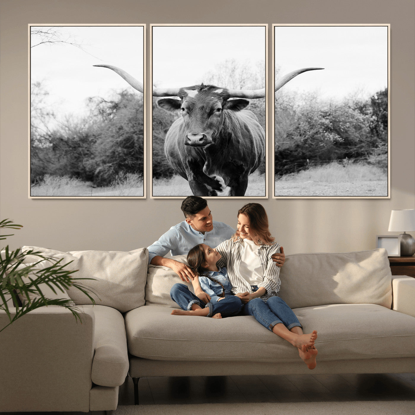 Black and white photo of a longhorn cow in a field, perfect for rustic farmhouse or western-themed interior wall decoration.