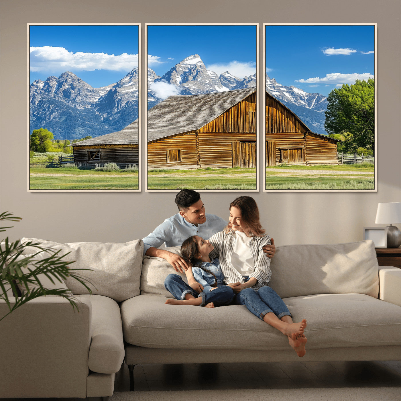 A rustic wooden barn sits in front of towering mountain peaks under a clear blue sky, perfect for farmhouse or cabin style interiors.
