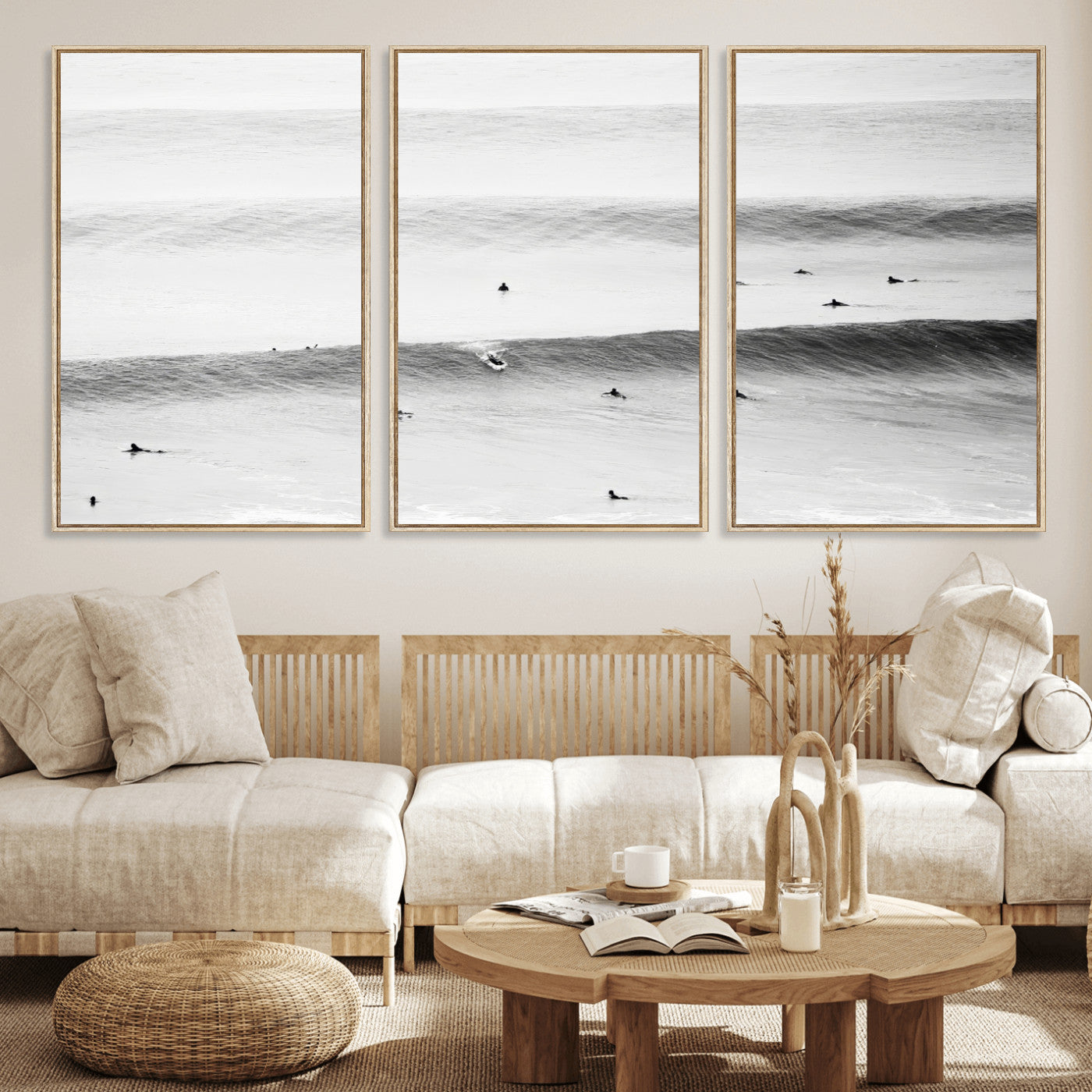 A monochrome photograph of swimmers gliding through gentle ocean waves, evoking a sense of calm and movement.