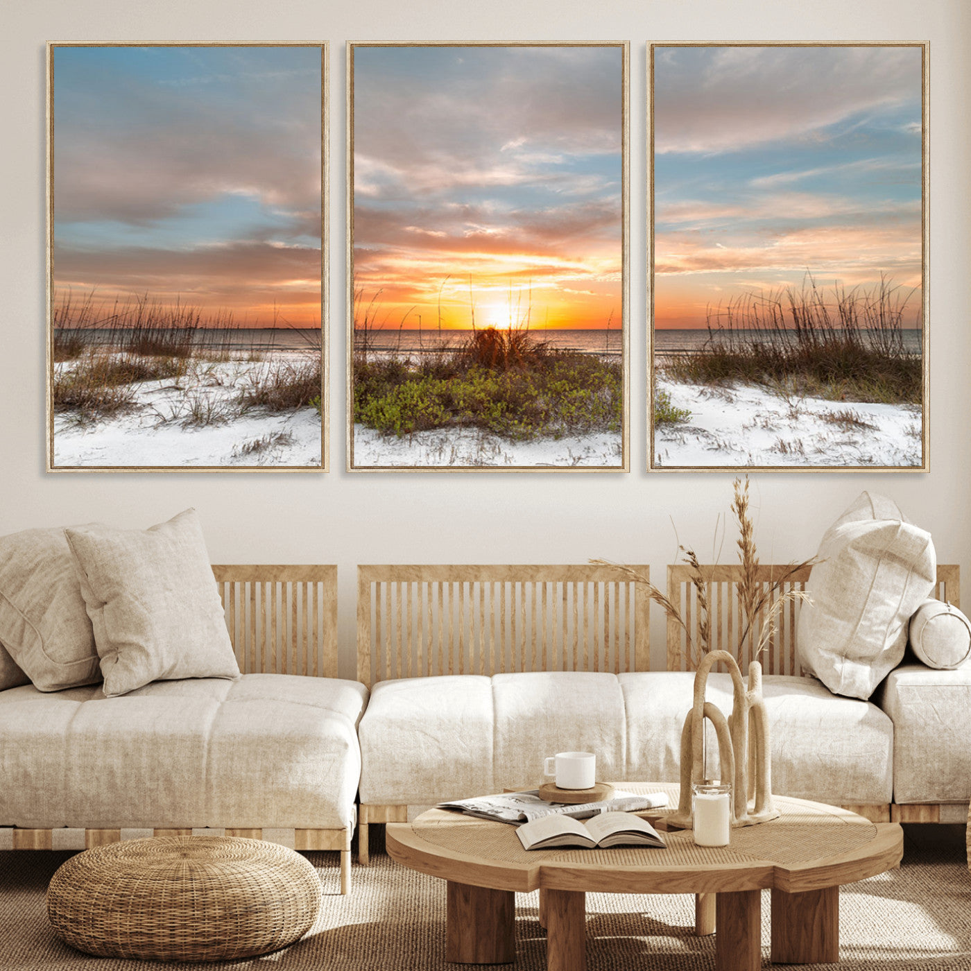A tranquil beach scene featuring golden sunset hues over the water, with grasses in the foreground and a peaceful, serene atmosphere.
