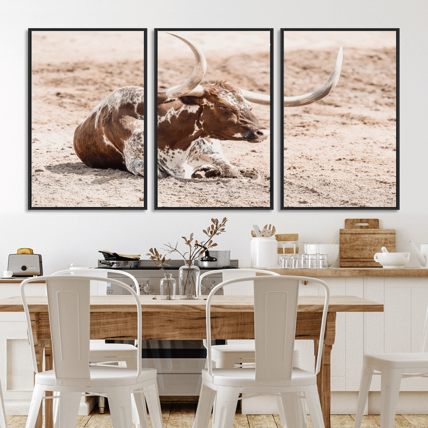 Texas Longhorn bull resting on dusty ground with warm tones, ideal for rustic western or farmhouse-themed wall decor.