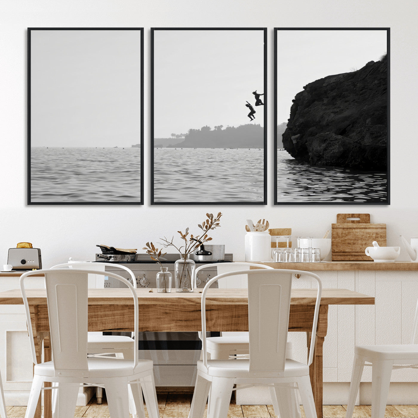 Black and white canvas of two figures cliff jumping into the sea, captured with moody tones, ideal for modern coastal or adventure-themed home decor. 2/2