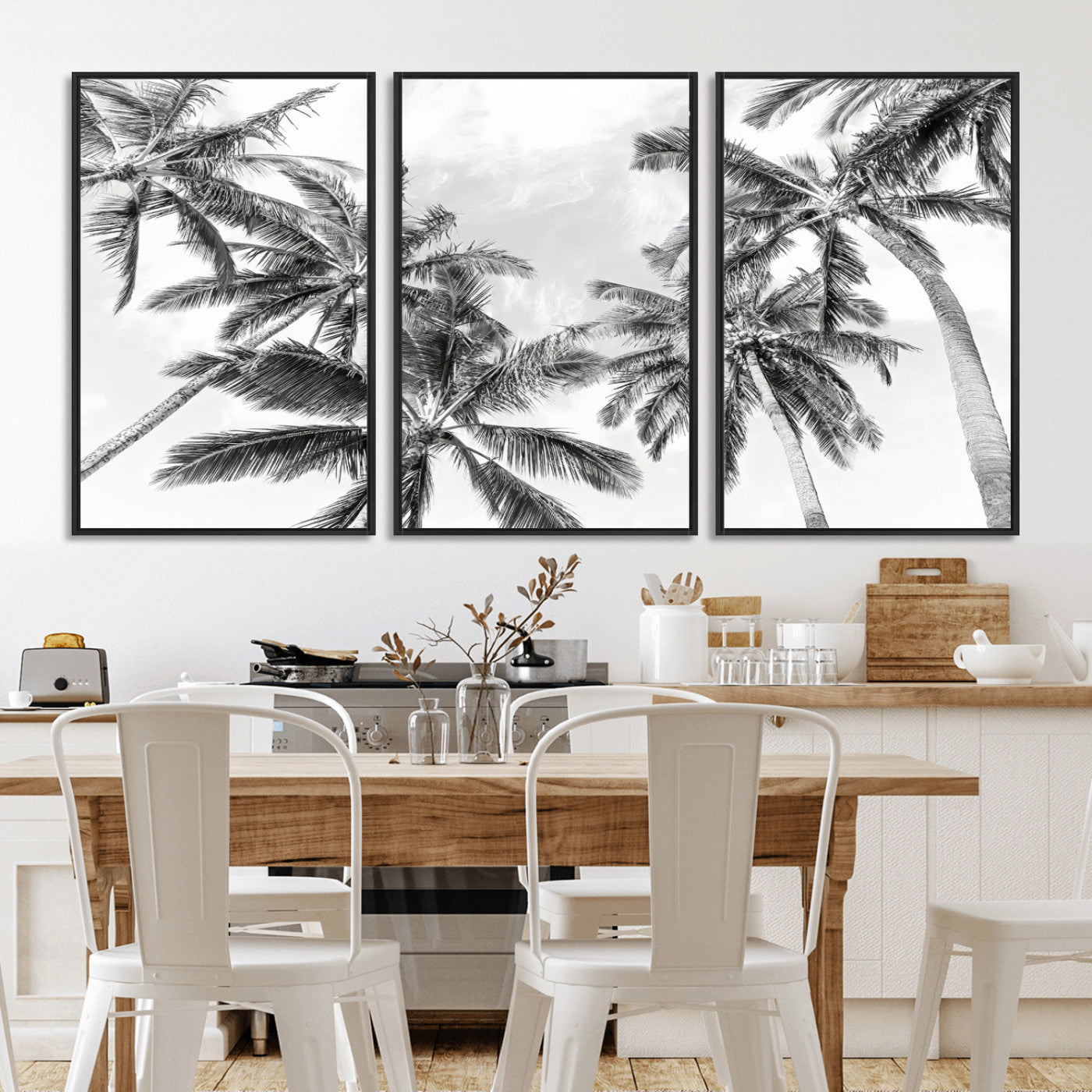 Black and white tropical palm trees viewed from below, swaying gently against a bright sky, creating a serene and elegant coastal atmosphere.