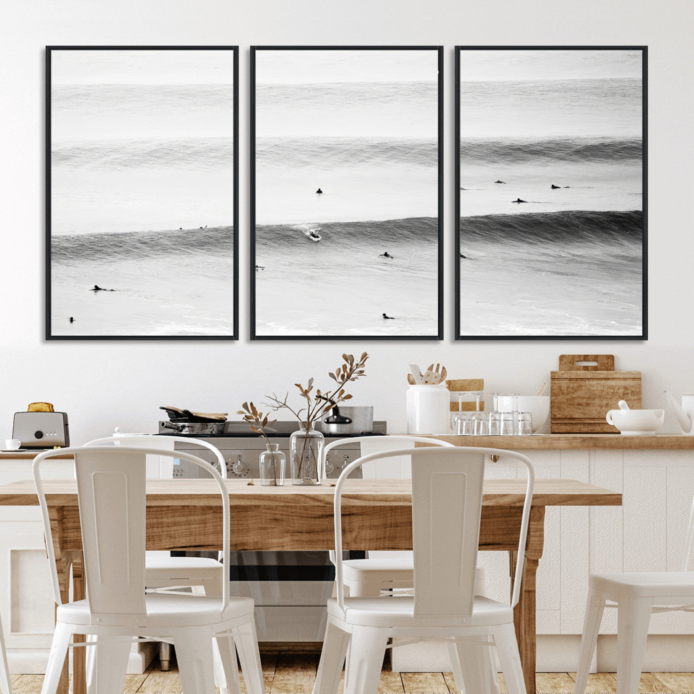 A monochrome photograph of swimmers gliding through gentle ocean waves, evoking a sense of calm and movement.