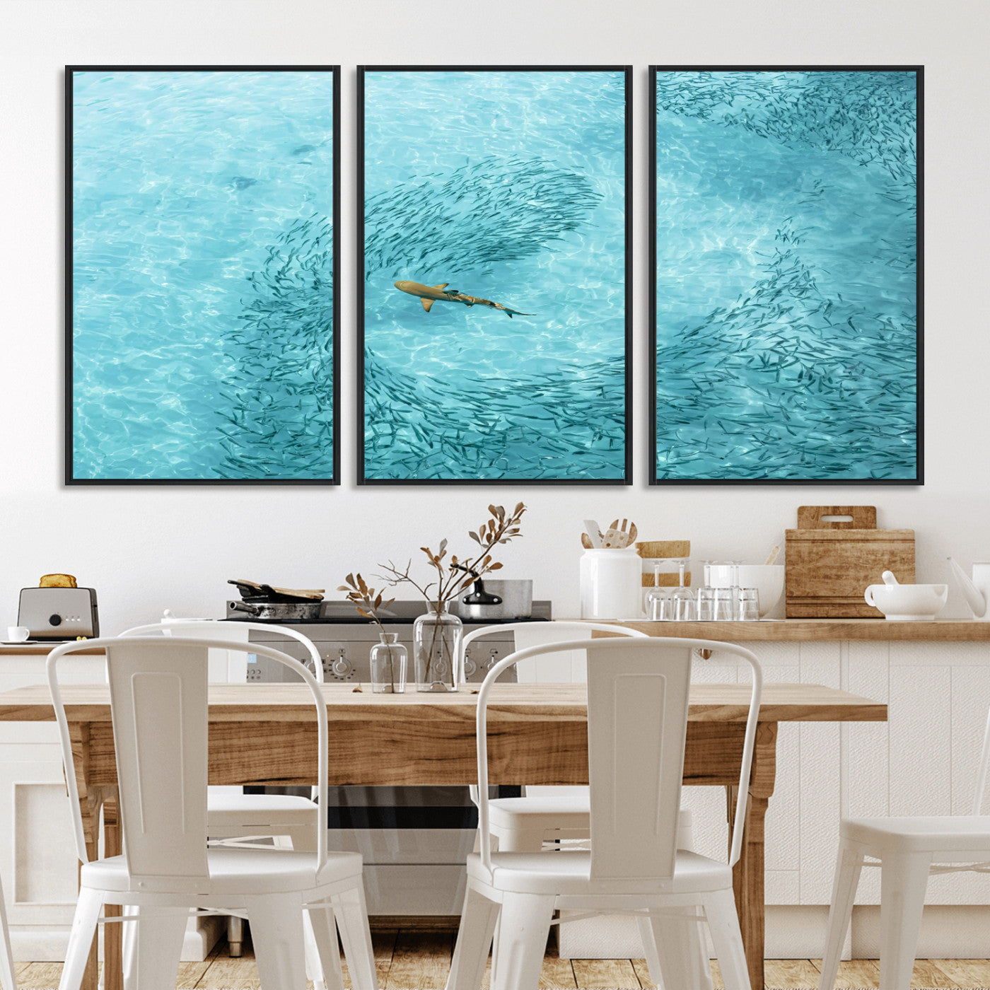 Aerial view of a shark swimming through a swirl of fish in clear turquoise waters, perfect for calm coastal or beach house decor.