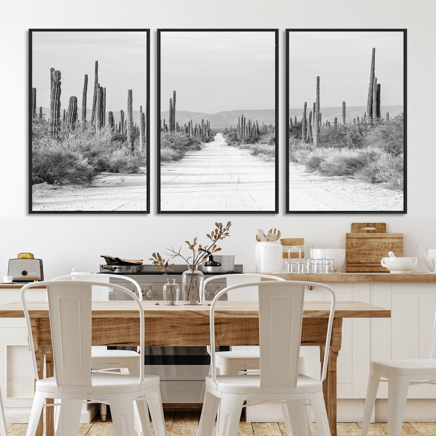 A black and white desert road stretching through a cactus-filled landscape, creating a rugged and timeless southwestern aesthetic with a sense of adventure.