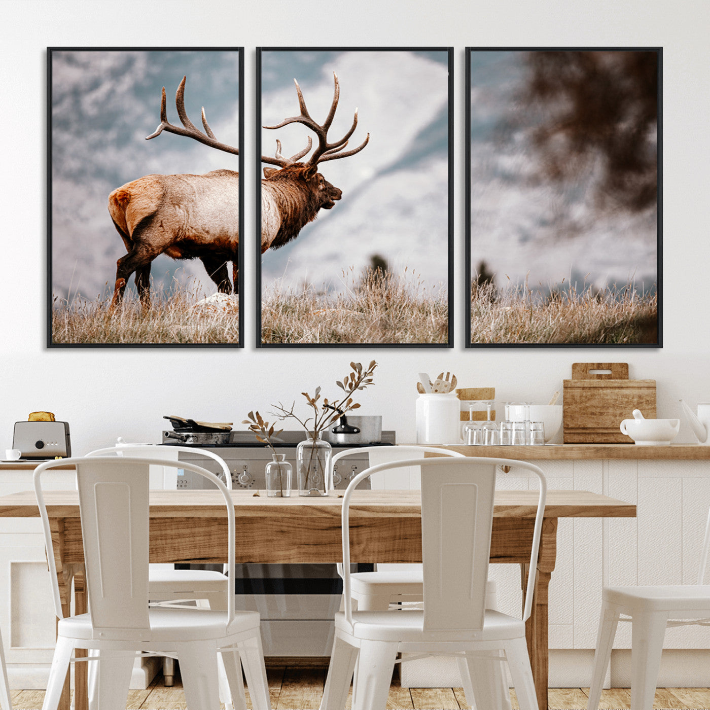 Majestic elk with large antlers standing in grass with snowy mountains in background, perfect for rustic cabin or lodge style decor.