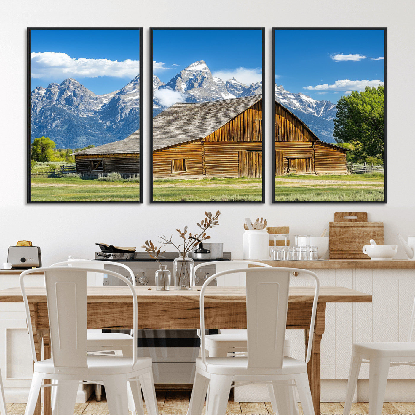 A rustic wooden barn sits in front of towering mountain peaks under a clear blue sky, perfect for farmhouse or cabin style interiors.