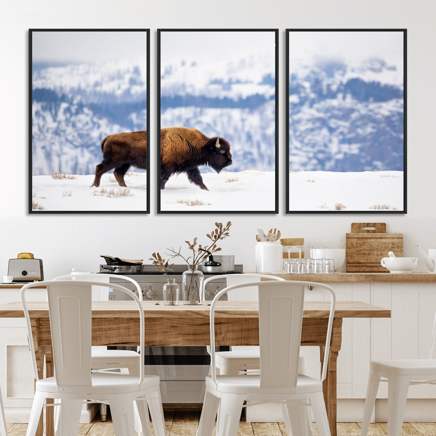 A lone bison walks across snowy ground with blue-toned mountain range behind, ideal for rustic or western farmhouse interiors.