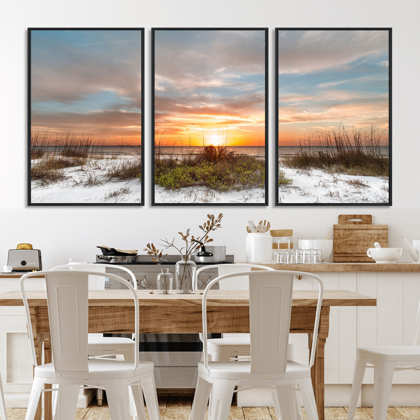 A tranquil beach scene featuring golden sunset hues over the water, with grasses in the foreground and a peaceful, serene atmosphere.