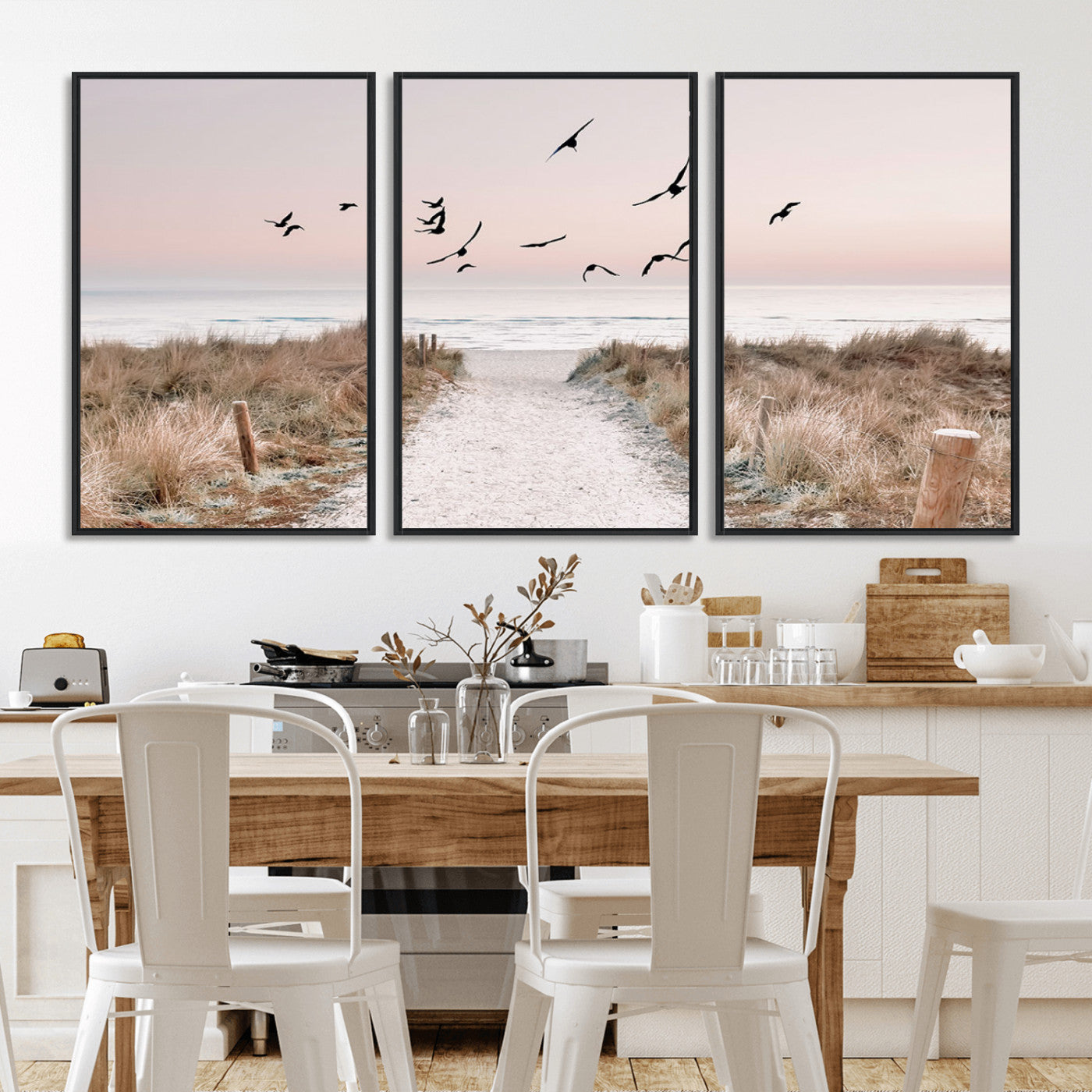 A peaceful coastal pathway leading to the ocean, with birds flying across a soft pastel sky, creating a calm and scenic beach atmosphere.