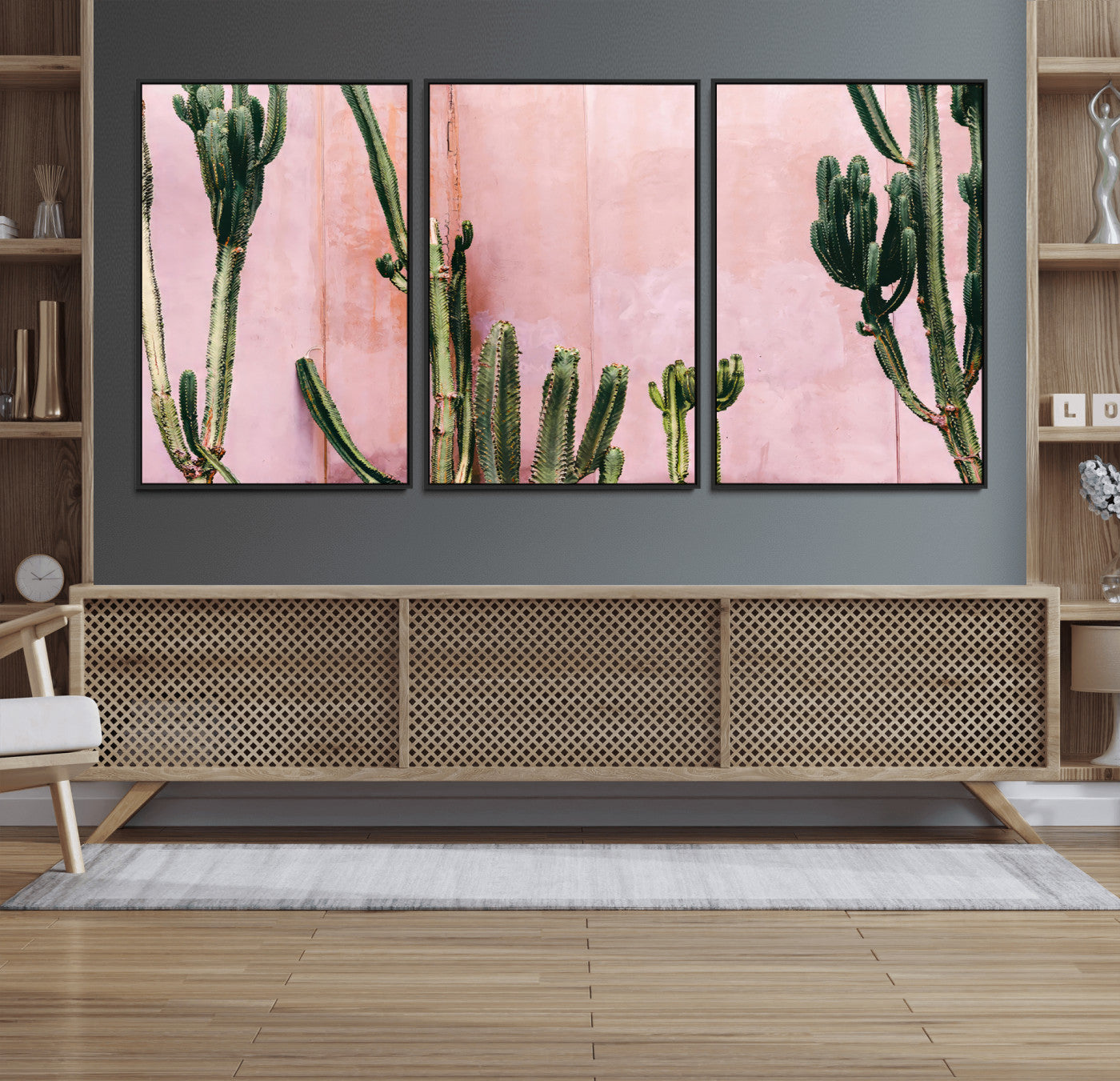 Framed canvas of tall green cacti against a soft pink wall, ideal for modern desert or colorful southwest-inspired home decor.