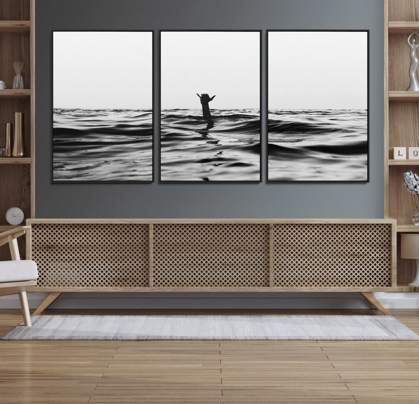 Black and white ocean with a hand making a surfer sign among dark waves, creating a dramatic and minimalist seascape with bold contrast.