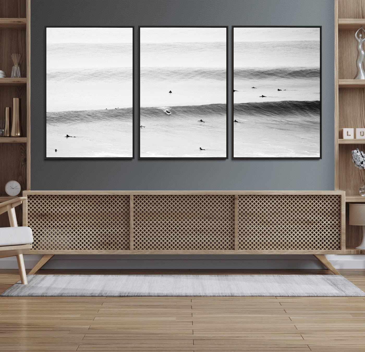 A monochrome photograph of swimmers gliding through gentle ocean waves, evoking a sense of calm and movement.