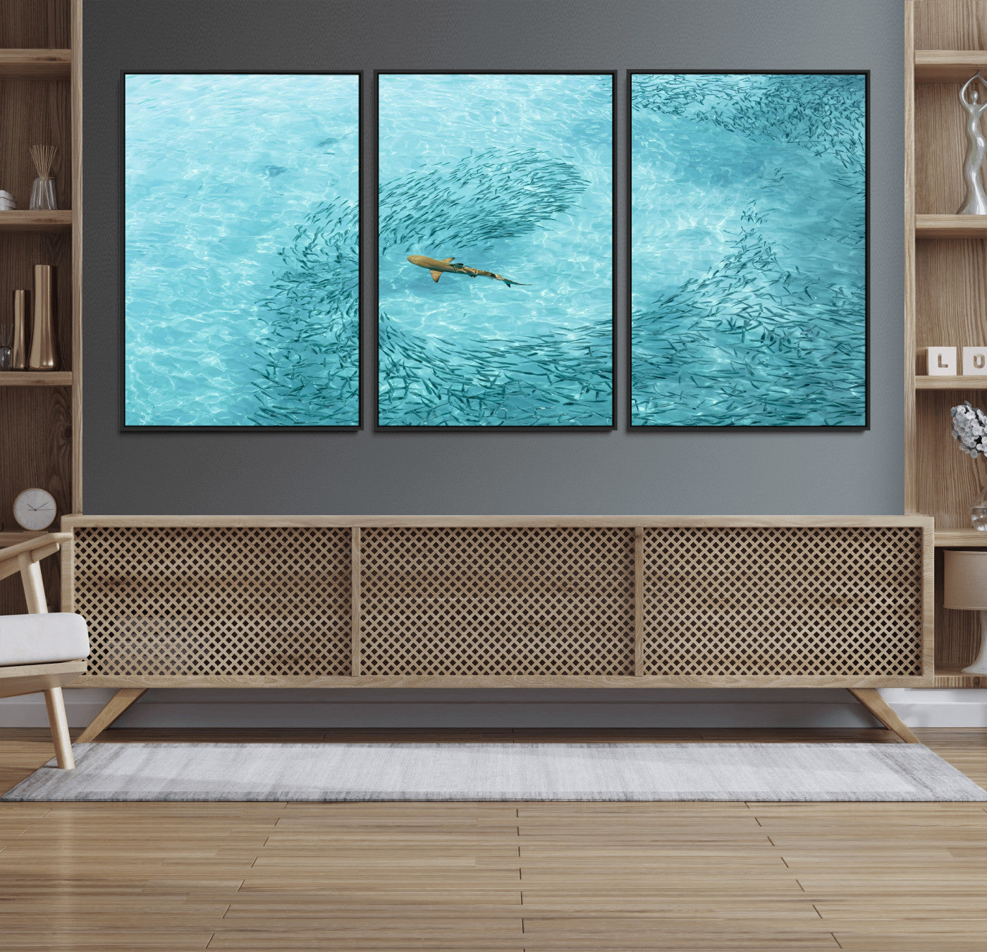Aerial view of a shark swimming through a swirl of fish in clear turquoise waters, perfect for calm coastal or beach house decor.