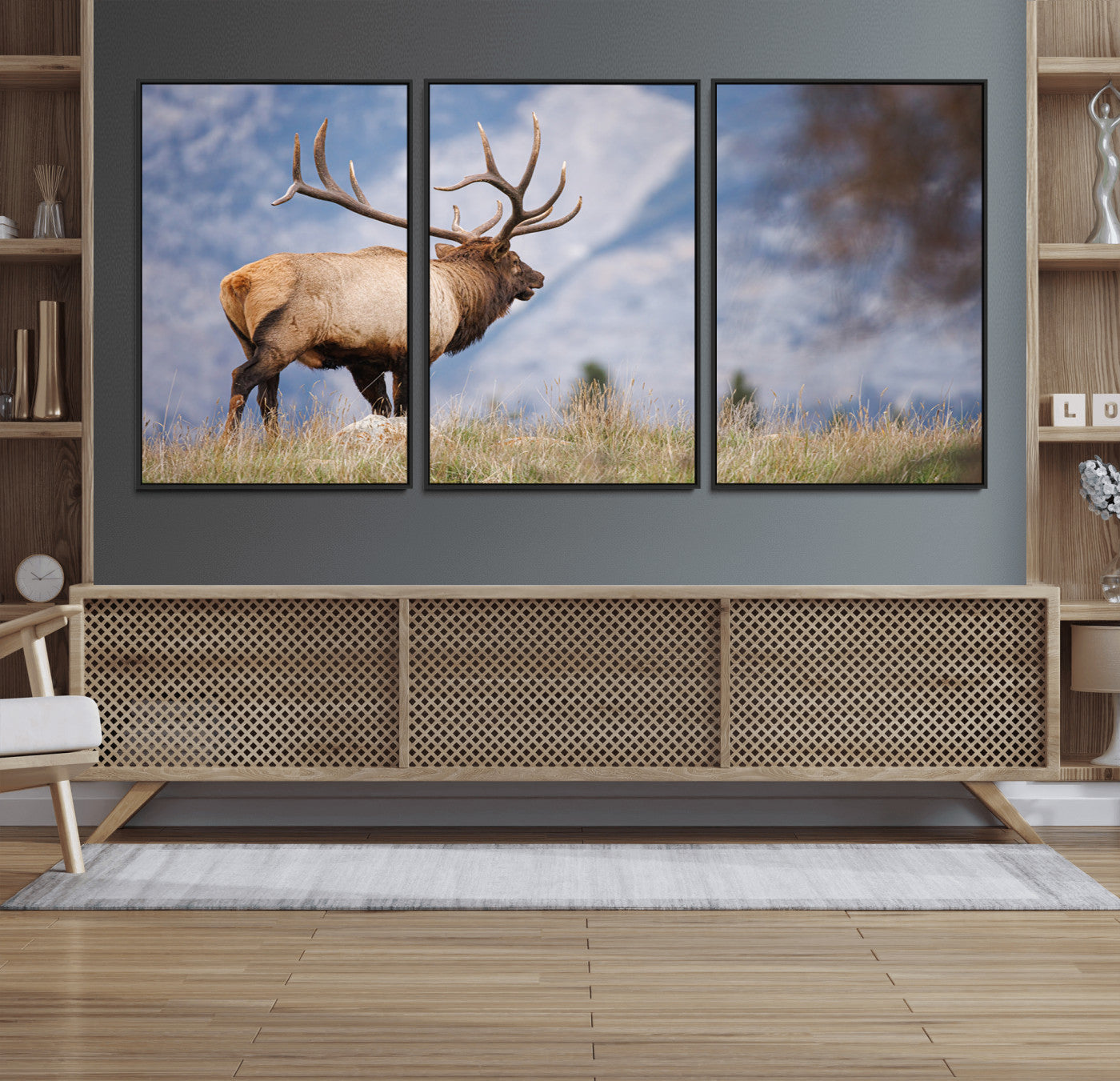 Elk with antlers standing on grass with mountain background, ideal for rustic, cabin, or lodge-inspired wall decor.