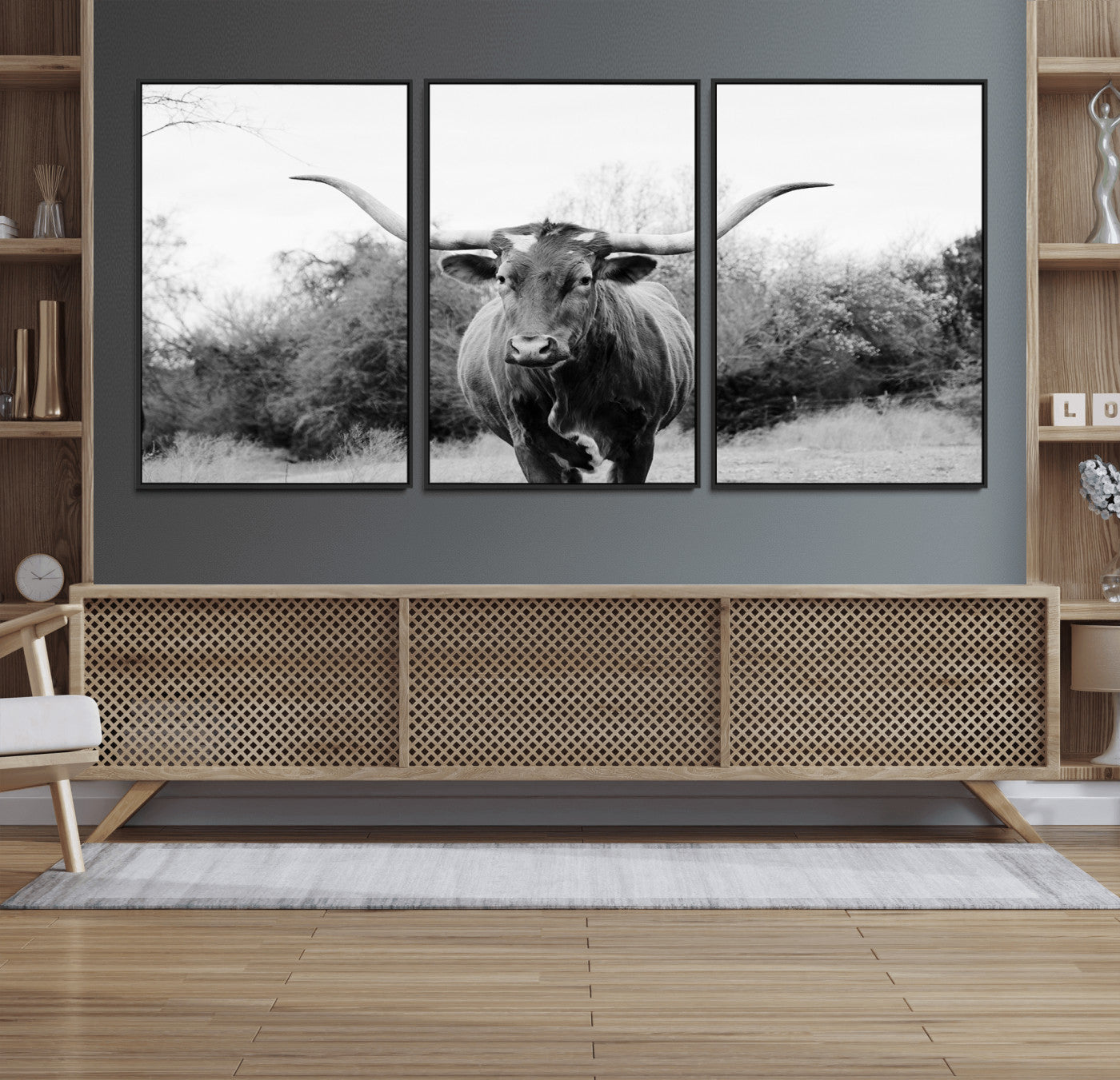 Black and white photo of a longhorn cow in a field, perfect for rustic farmhouse or western-themed interior wall decoration.