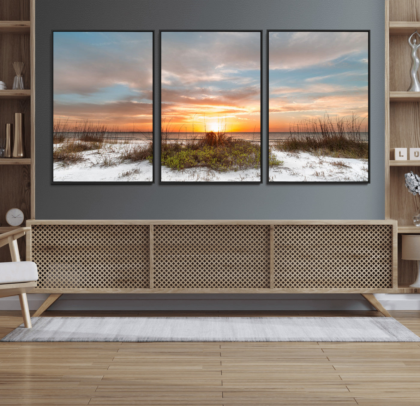 A tranquil beach scene featuring golden sunset hues over the water, with grasses in the foreground and a peaceful, serene atmosphere.