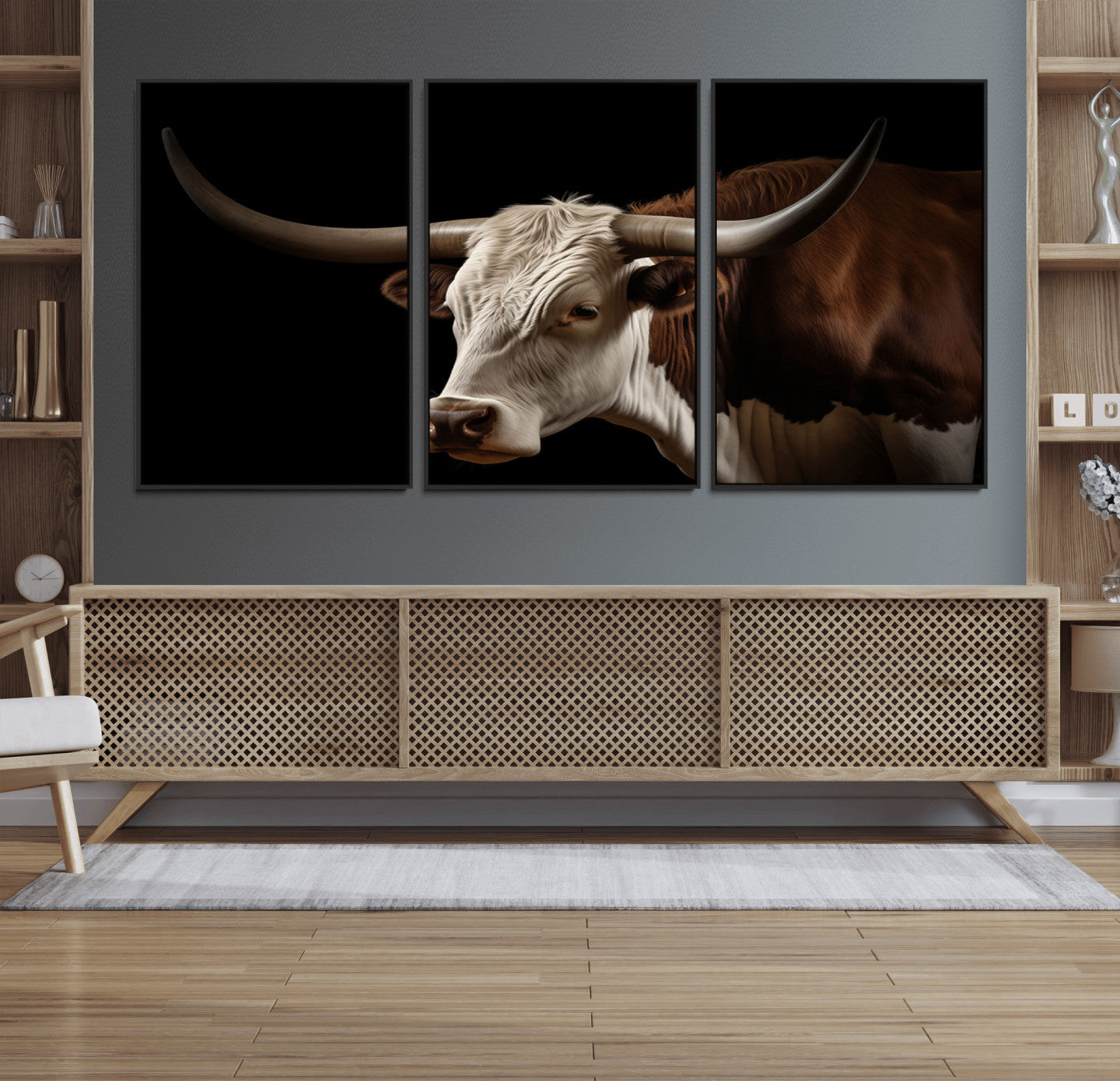 "Close-up of a brown and white longhorn cow with prominent curved horns against a black background."