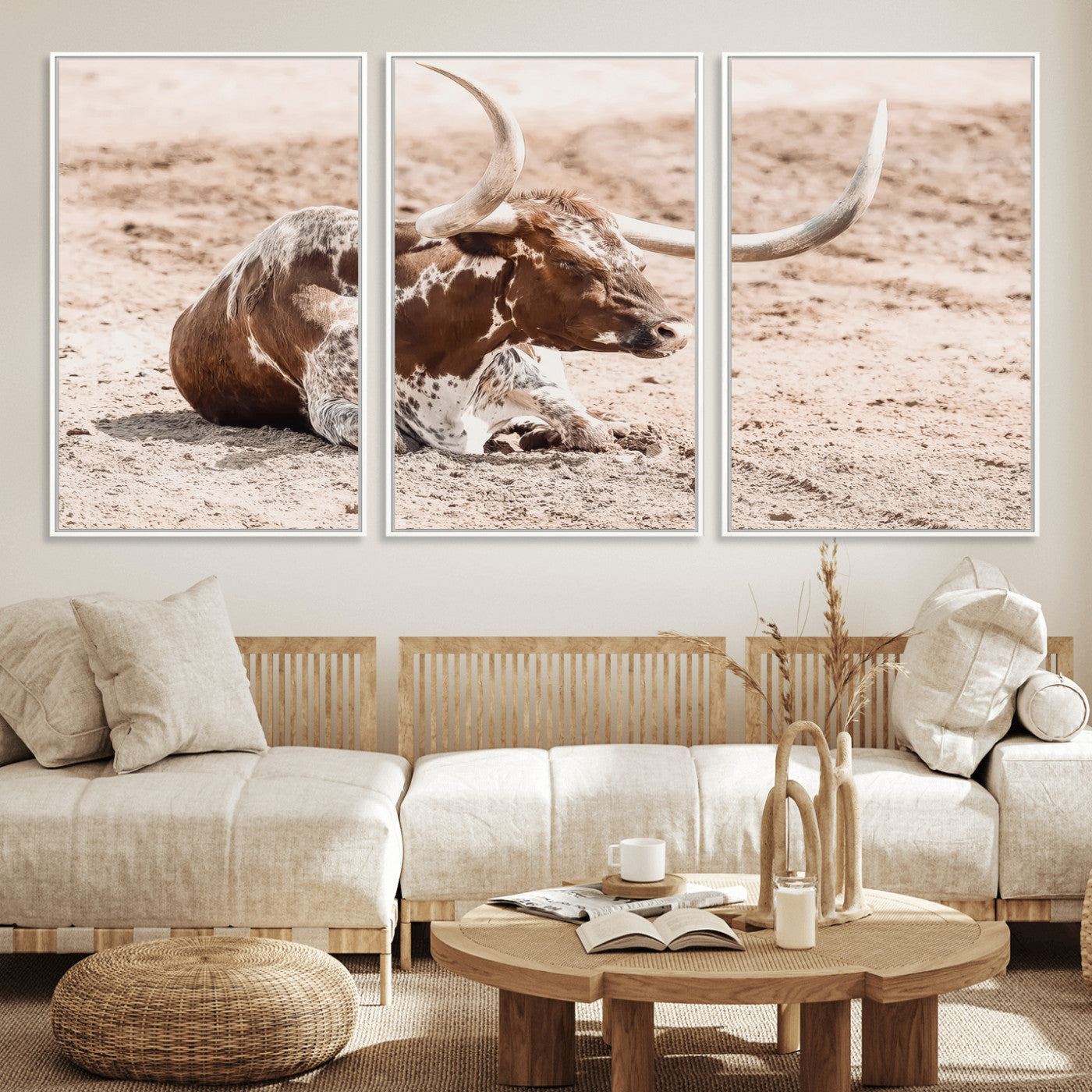 Texas Longhorn bull resting on dusty ground with warm tones, ideal for rustic western or farmhouse-themed wall decor.