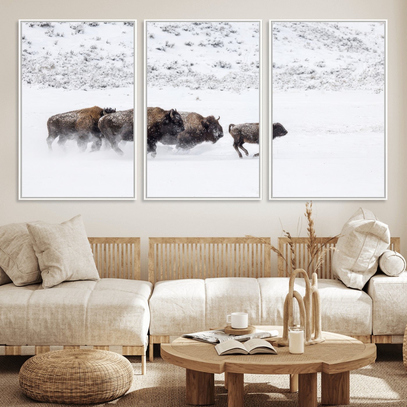 Bison herd running through a snowy open field with mountain backdrop, perfect for rustic or western-themed wall decoration.
