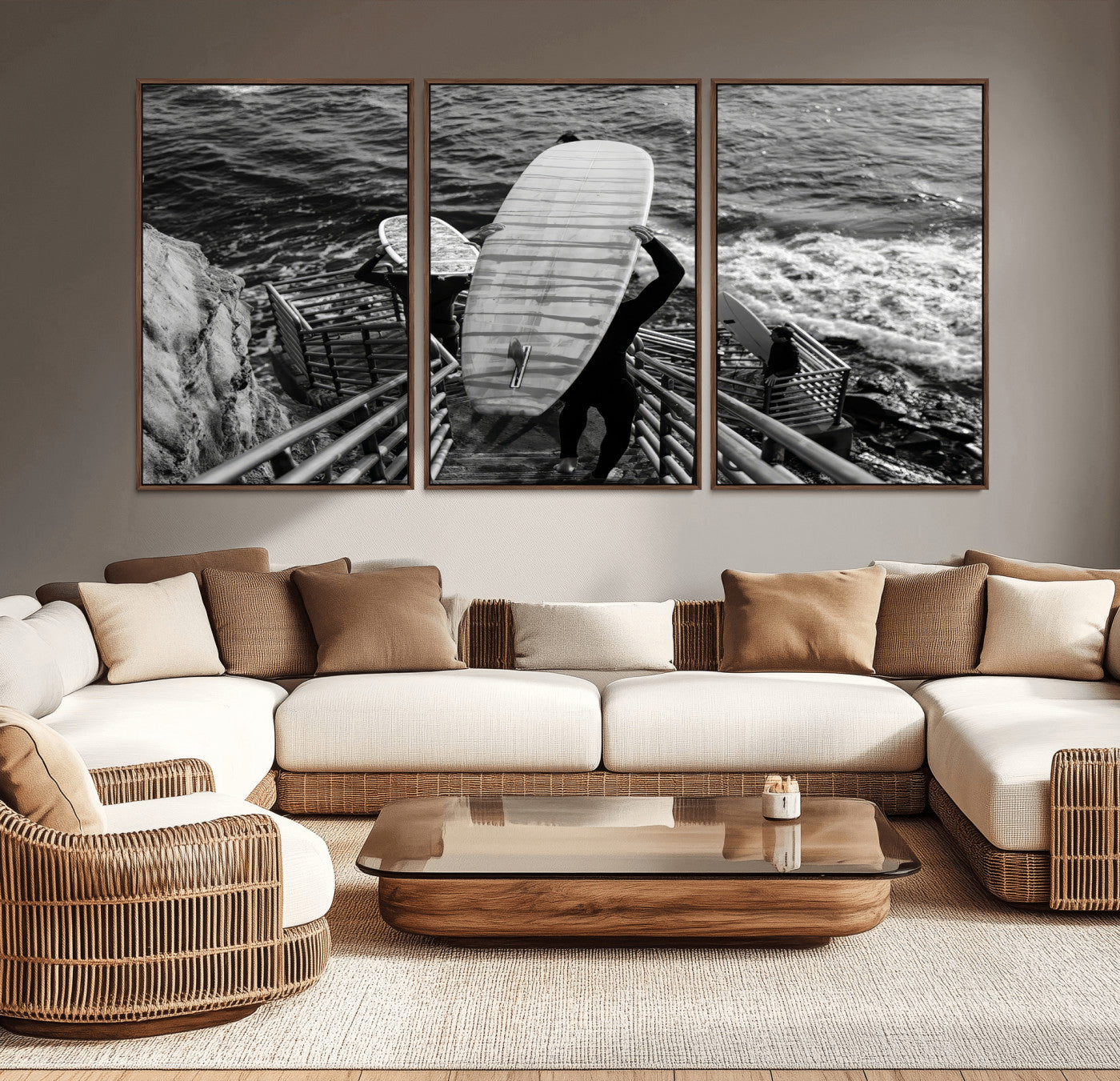 Black and white photo of surfers carrying boards down a rugged cliffside stairway, capturing a bold and adventurous coastal scene.