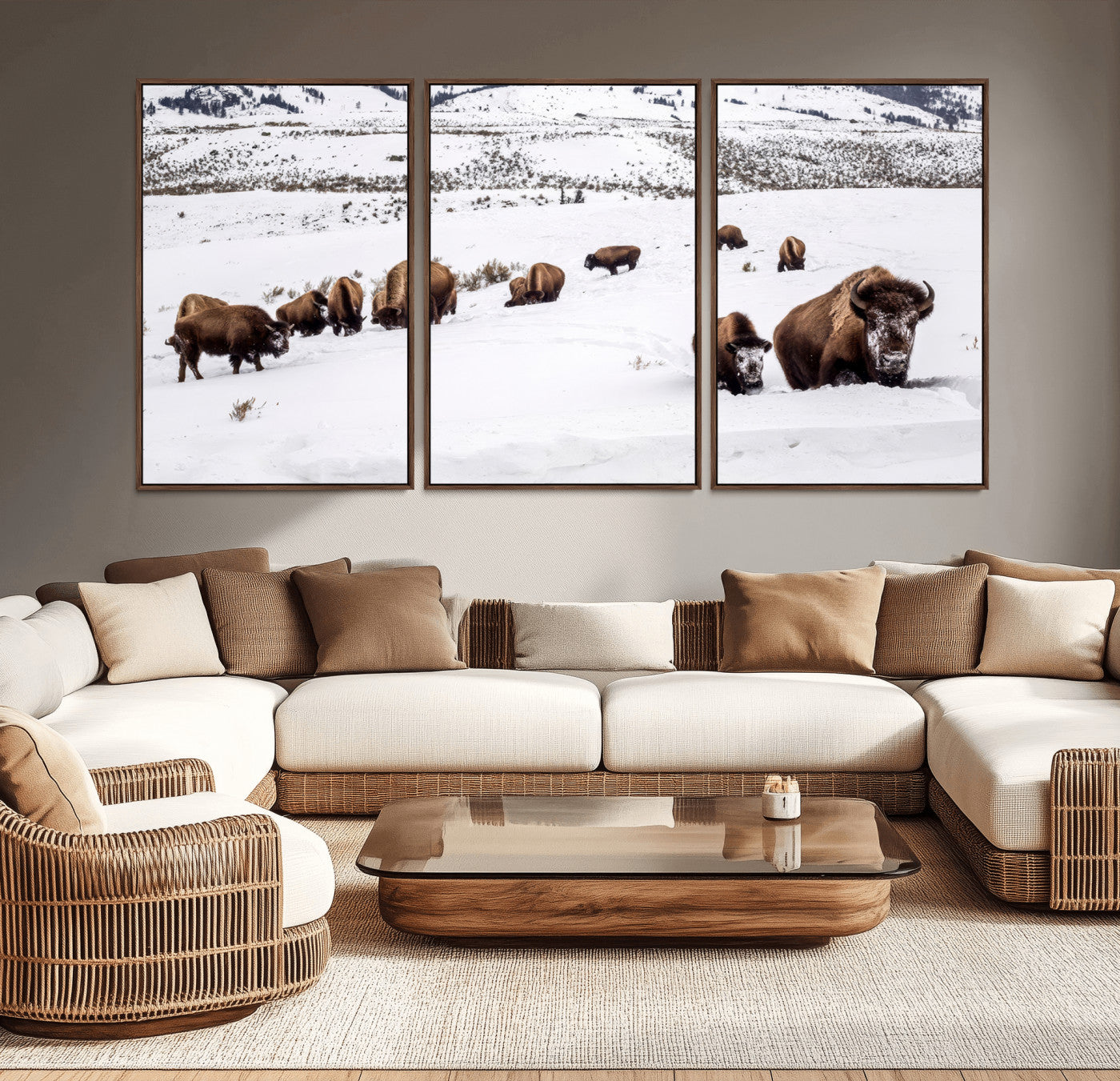 A herd of bison walking through deep snow in a mountain valley, perfect for rustic, cabin or western-themed wall decor.