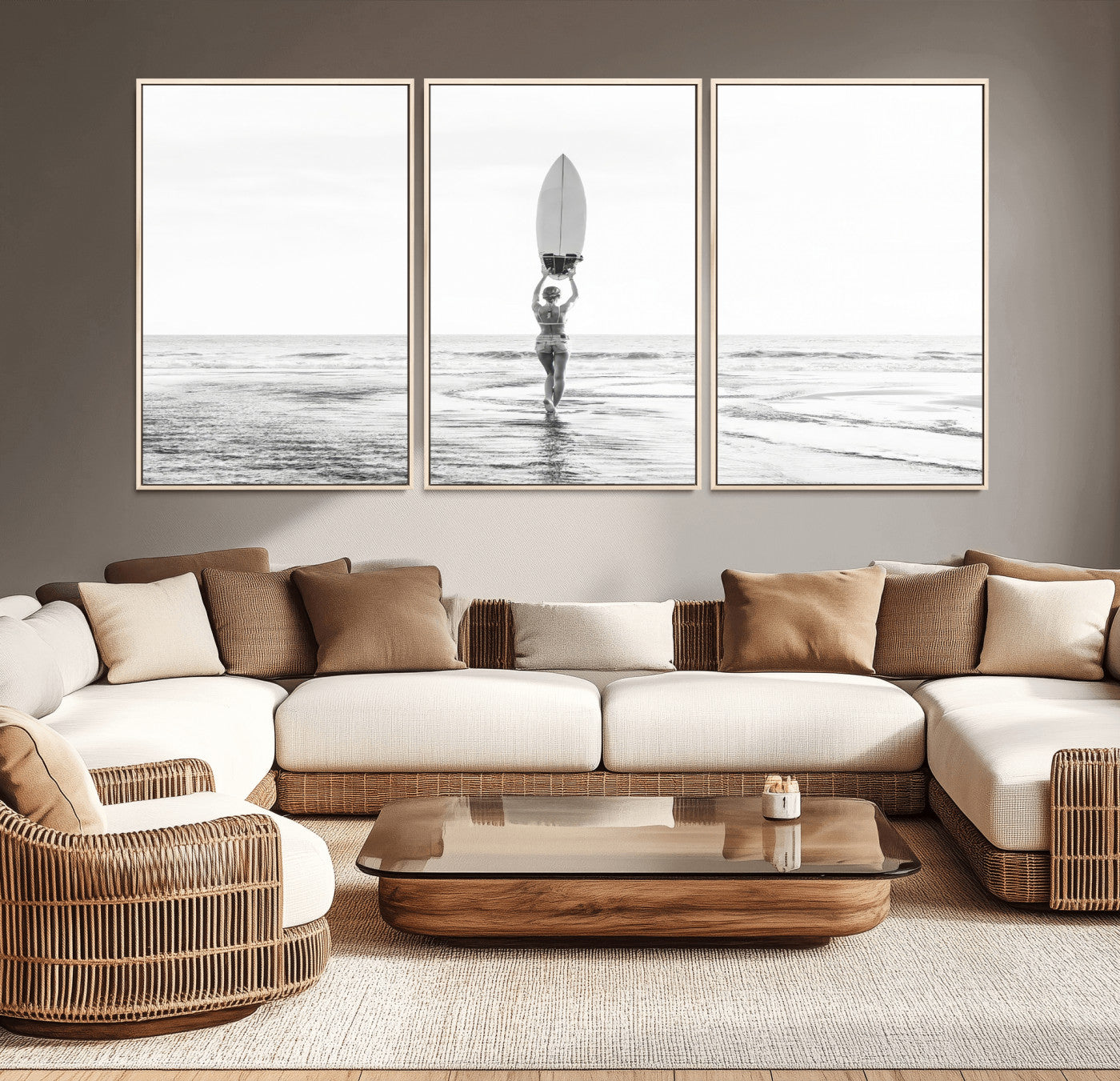 Black and white image of a female surfer holding a surfboard above her head while walking toward the ocean, creating a minimalist and bold coastal aesthetic.