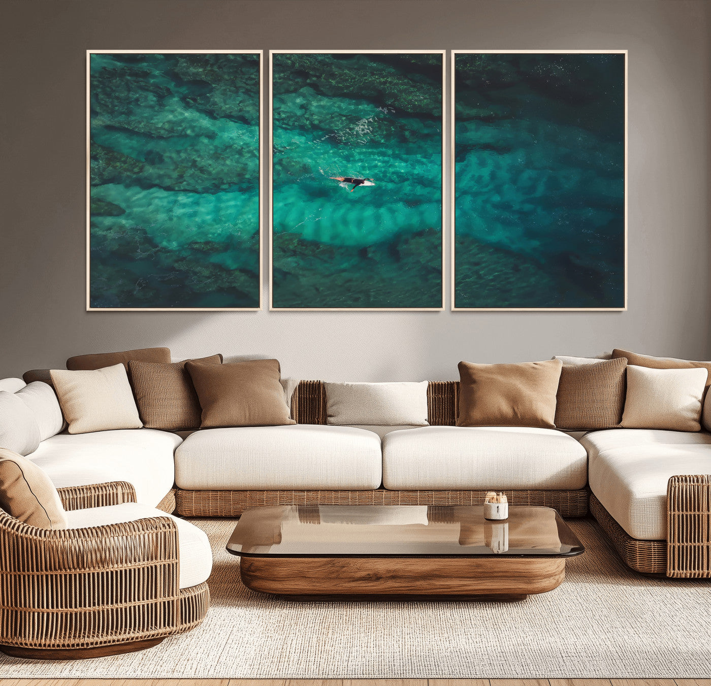 An aerial view of a solo surfer paddling through crystal-clear turquoise waters over a sunlit reef, capturing the beauty and serenity of open water surfing.