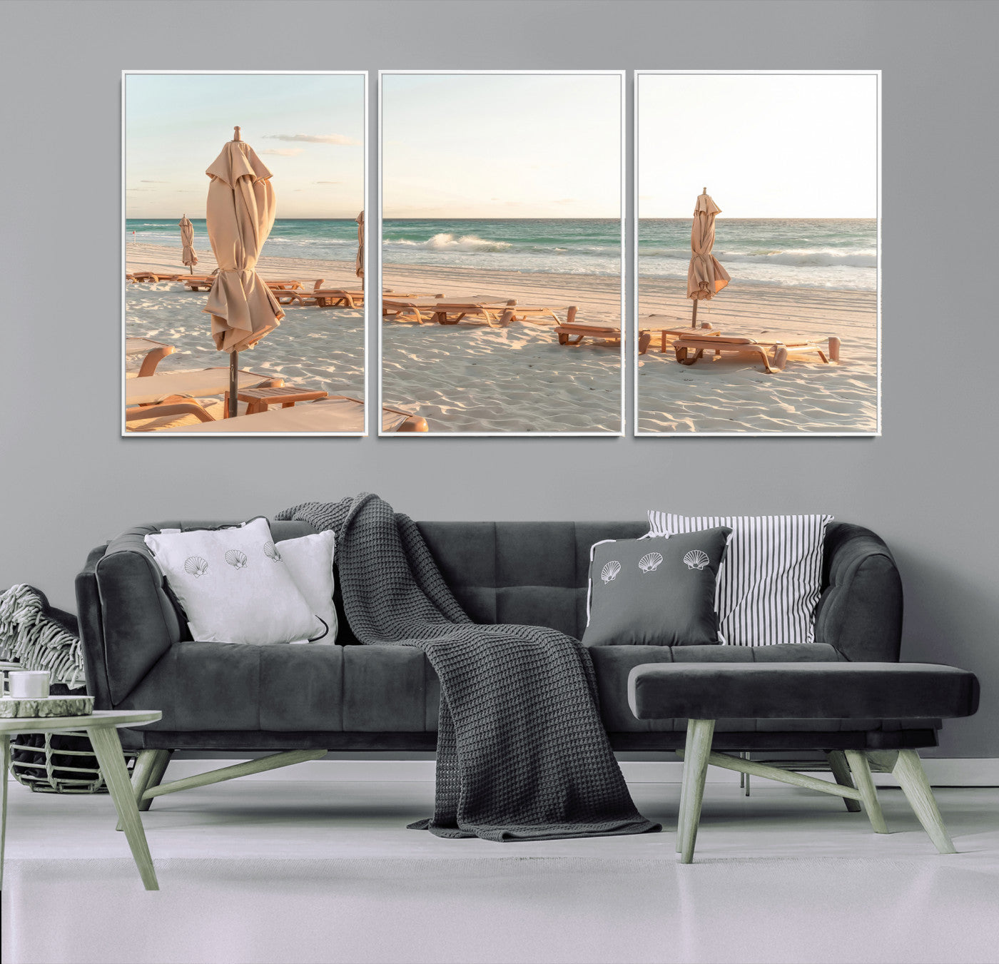 Minimalist photo of empty beach loungers and umbrellas on soft sand, ideal for calm seaside or pastel coastal-style home decor.