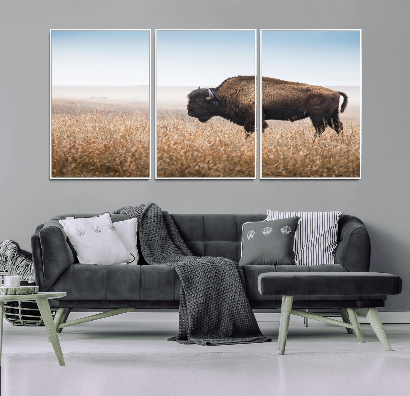 A majestic bison standing in an open prairie field, its strong form blending into the golden grass under a vast blue sky, evoking the wild spirit of the American plains.