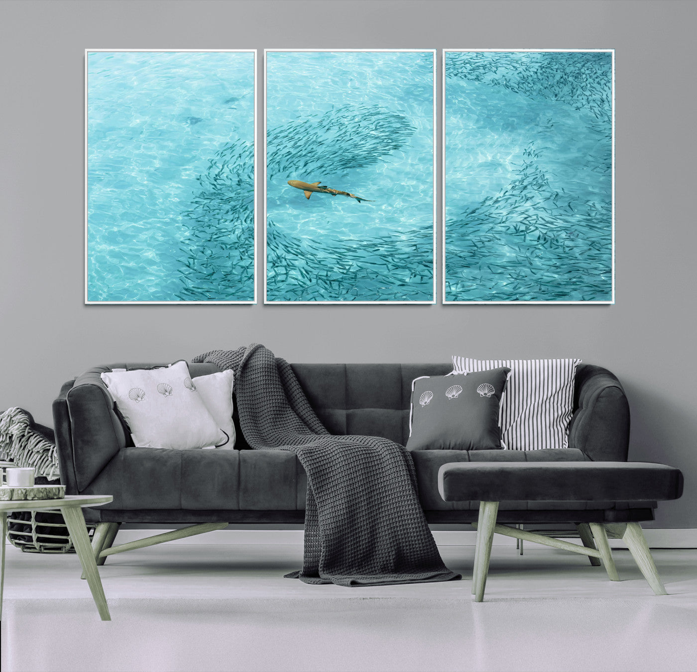 Aerial view of a shark swimming through a swirl of fish in clear turquoise waters, perfect for calm coastal or beach house decor.