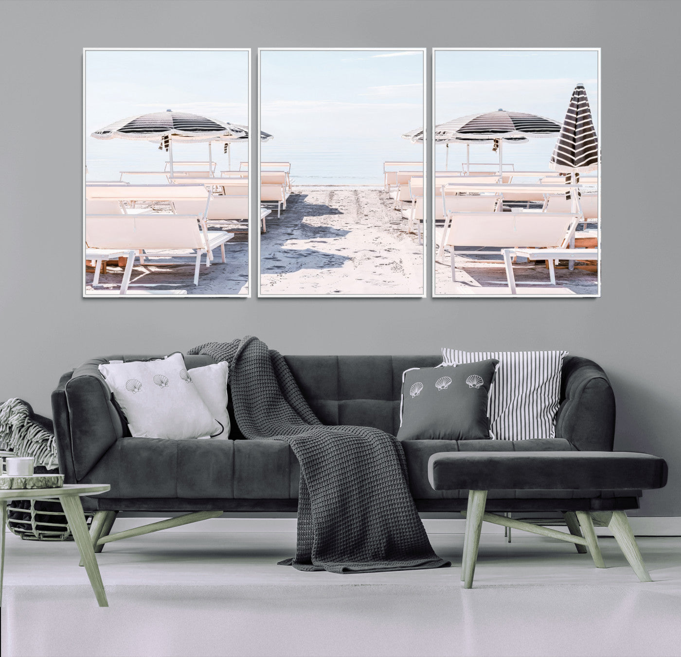 A serene minimalist beach scene featuring striped umbrellas, soft pastel sand, and an elegant lounge setup, creating a tranquil and stylish coastal retreat.