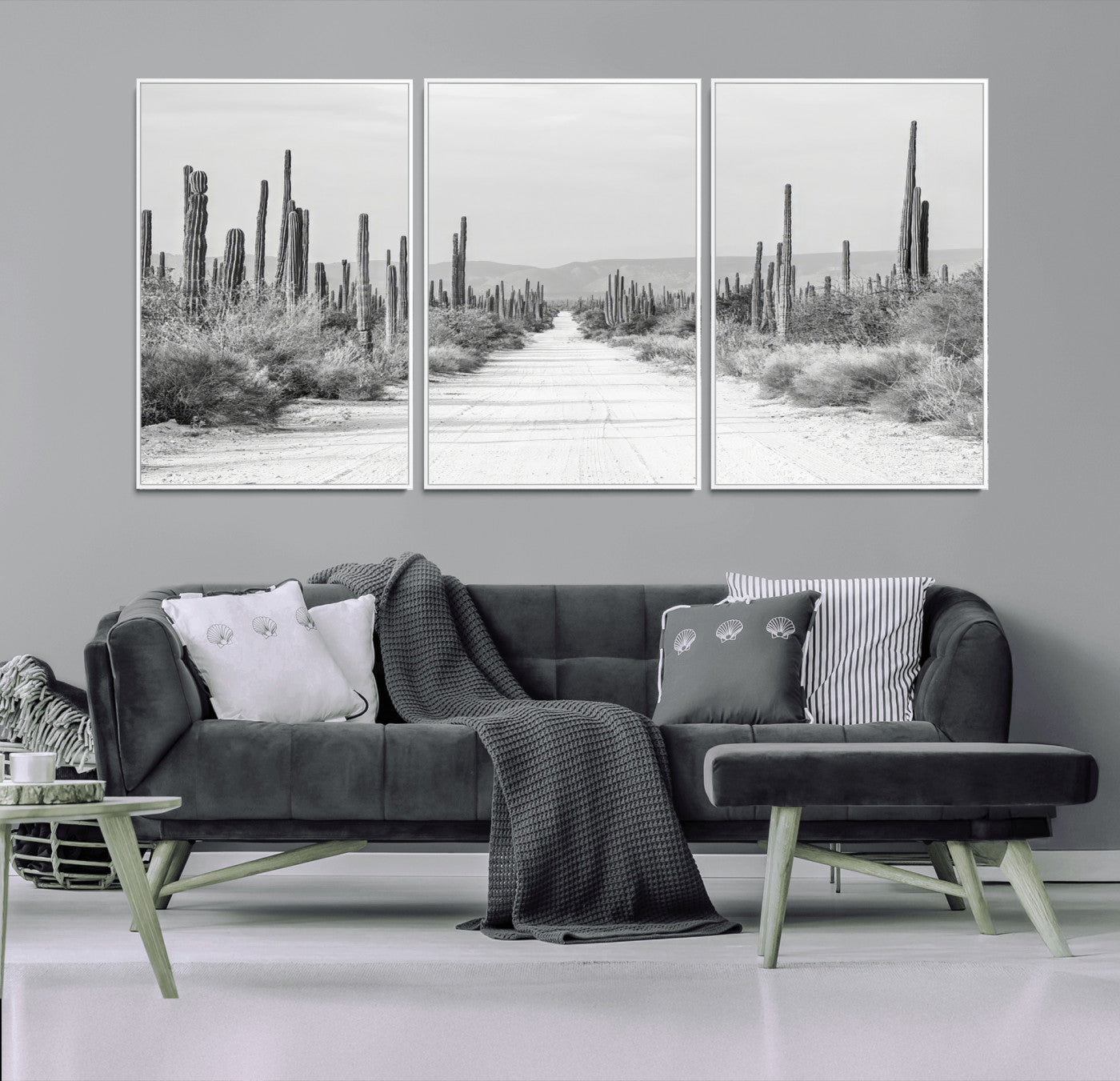 A black and white desert road stretching through a cactus-filled landscape, creating a rugged and timeless southwestern aesthetic with a sense of adventure.