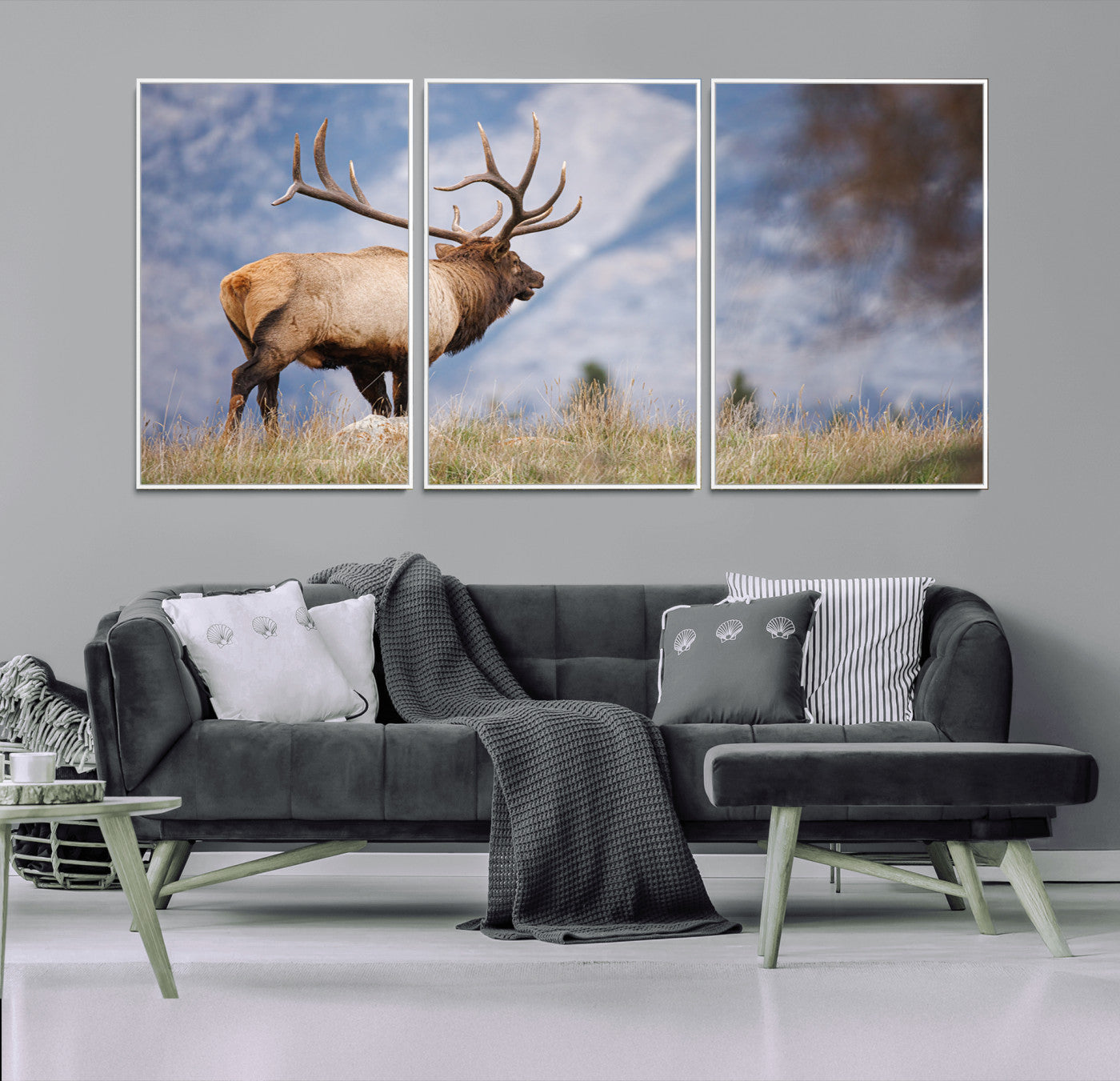 Elk with antlers standing on grass with mountain background, ideal for rustic, cabin, or lodge-inspired wall decor.