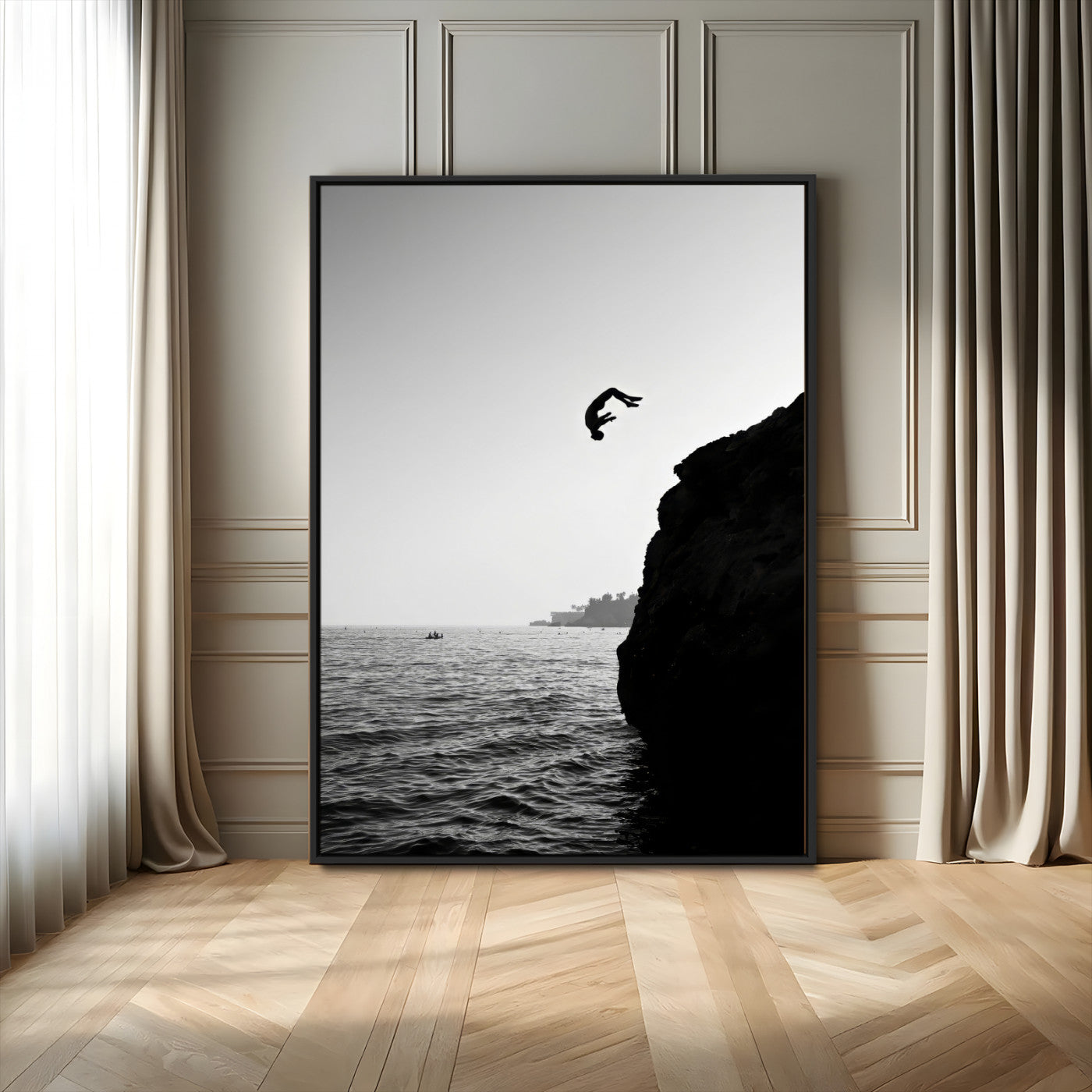Silhouette of a person mid-air during a cliff jump over the ocean, captured in black and white for minimalist adventure decor.