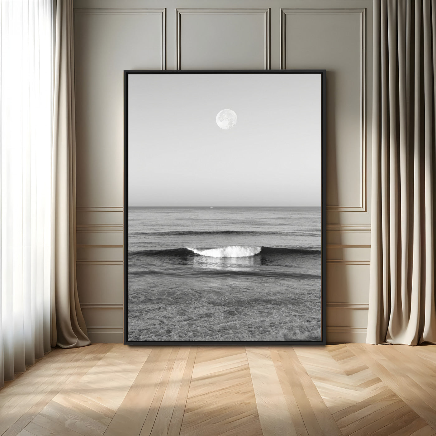 Black and white wall art of a calm ocean wave beneath a full moon, ideal for minimalist or monochrome coastal decor.