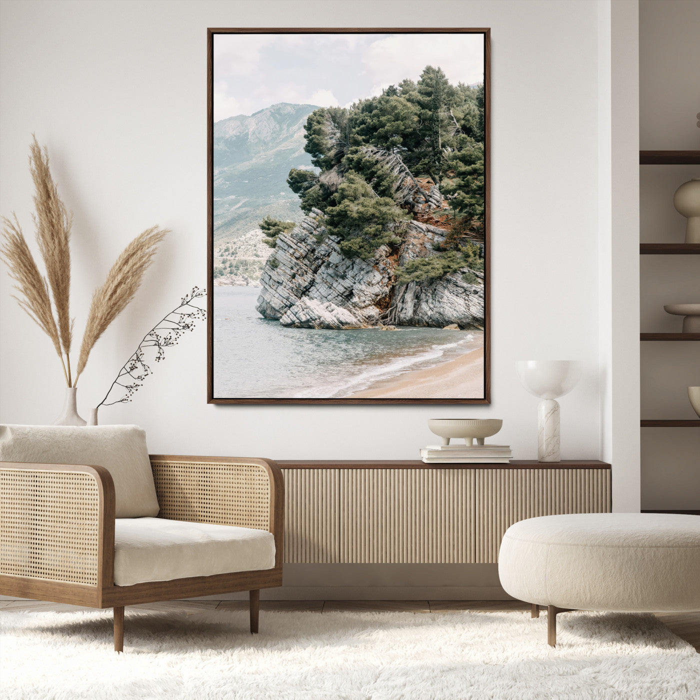 Framed photo of a rocky coastal cliff with dense greenery and calm shoreline, ideal for rustic coastal or earthy-toned home decor.