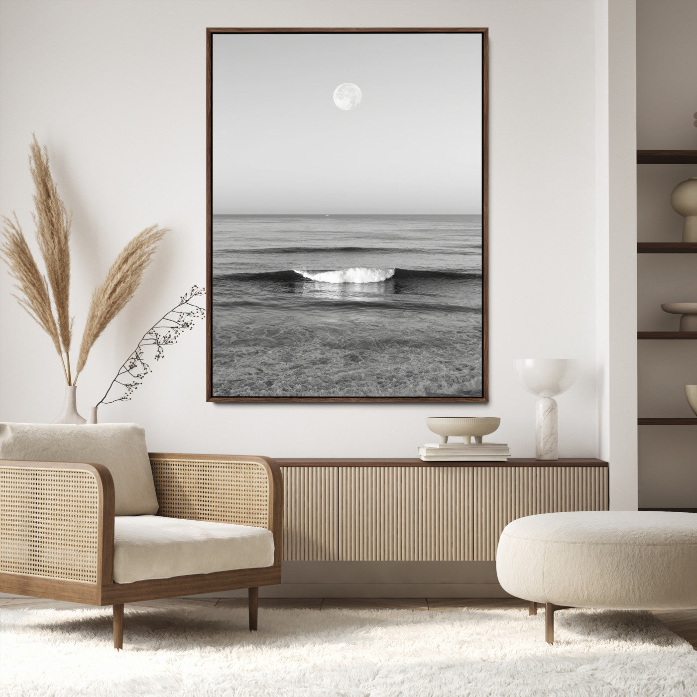 Black and white wall art of a calm ocean wave beneath a full moon, ideal for minimalist or monochrome coastal decor.